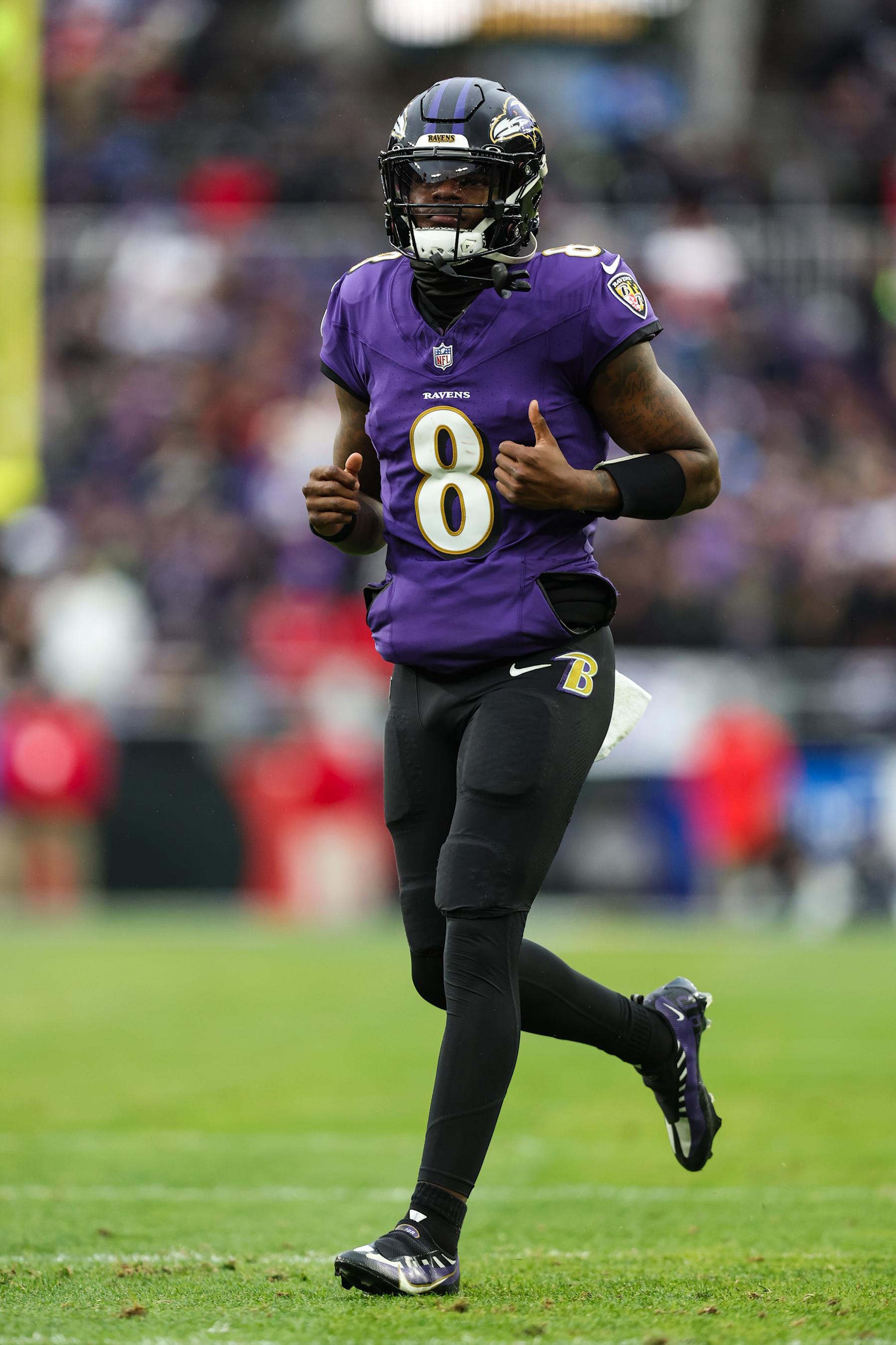 BALTIMORE, MD - JANUARY 28: Lamar Jackson #8 of the Baltimore Ravens runs across the field during the AFC Championship NFL football game against the Kansas City Chiefs at M&T Bank Stadium on January 28, 2024 in Baltimore, Maryland. (Photo by Perry Knotts/Getty Images)