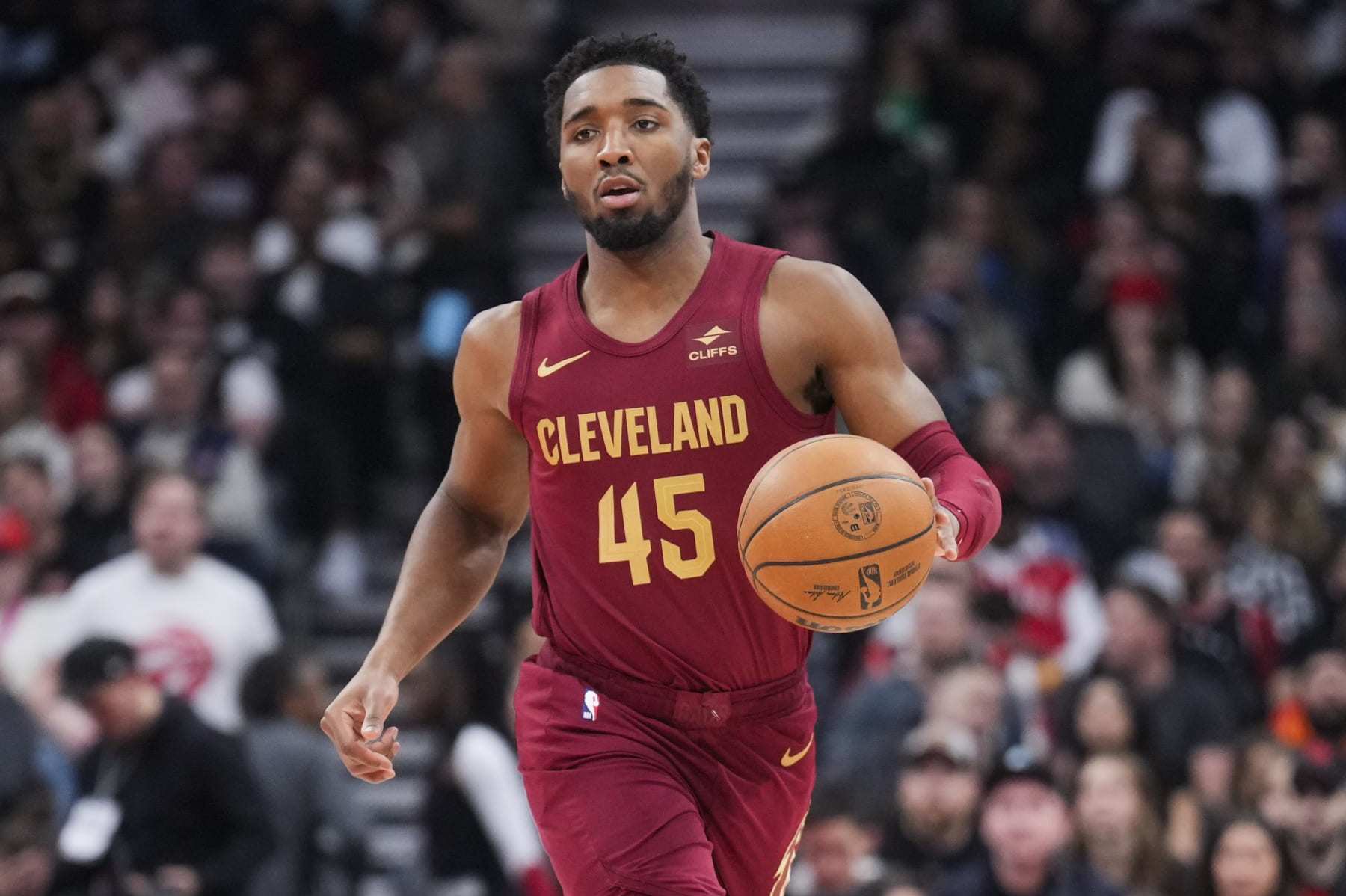 TORONTO, ON - JANUARY 1: Donovan Mitchell #45 of Cleveland Cavaliers dribbles against the Cleveland Cavaliers during the first half of their basketball game at the Scotiabank Arena on January 1, 2024 in Toronto, Ontario, Canada. NOTE TO USER: User expressly acknowledges and agrees that, by downloading and/or using this Photograph, user is consenting to the terms and conditions of the Getty Images License Agreement. (Photo by Mark Blinch/Getty Images)