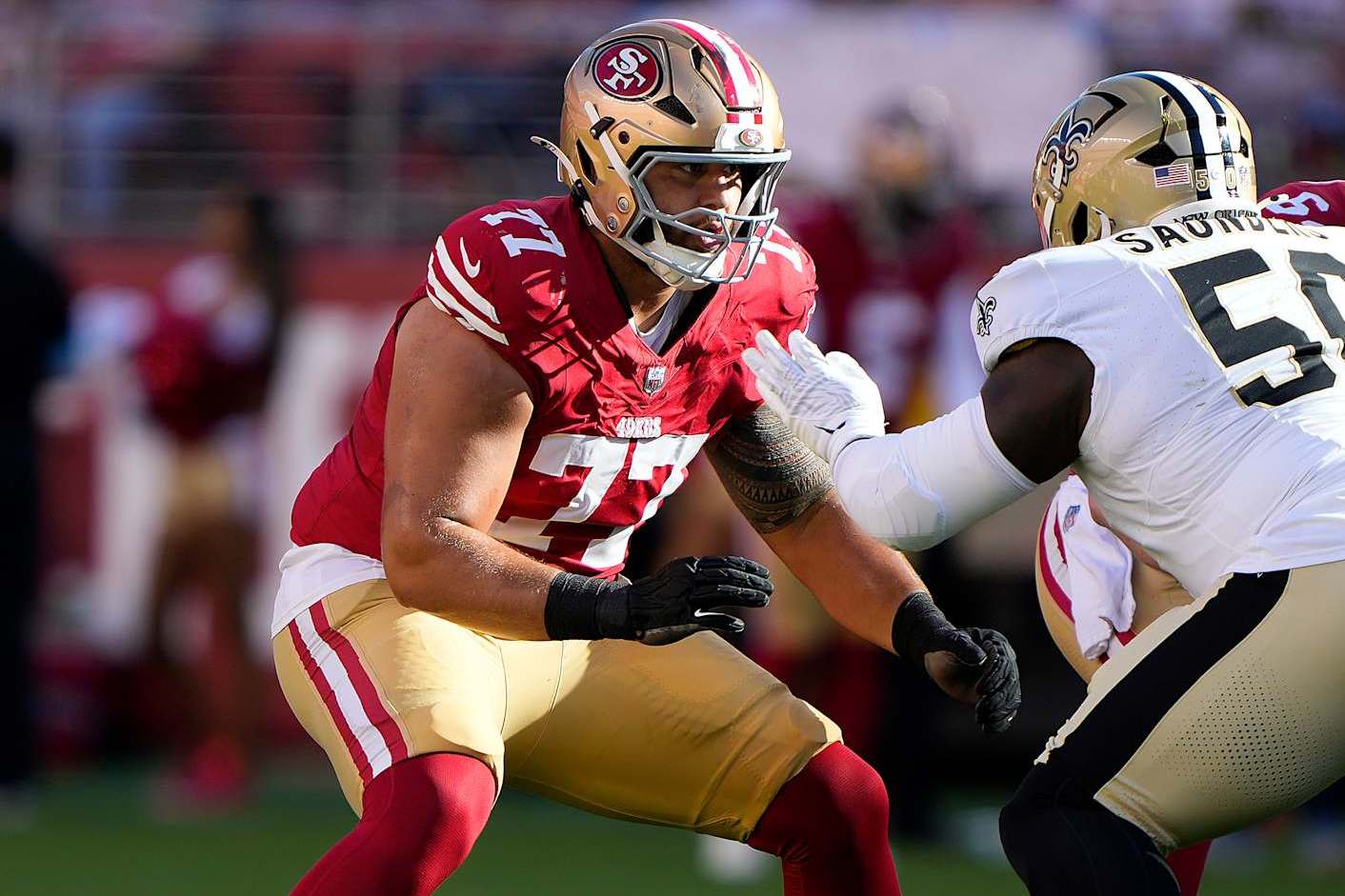 SANTA CLARA, CALIFORNIA - AUGUST 18: Dominick Puni #77 of the San Francisco 49ers pass blocks against Khalen Saunders #50 the New Orleans Saints during the first half of a preseason game at Levi's Stadium on August 18, 2024 in Santa Clara, California. (Photo by Thearon W. Henderson/Getty Images)
