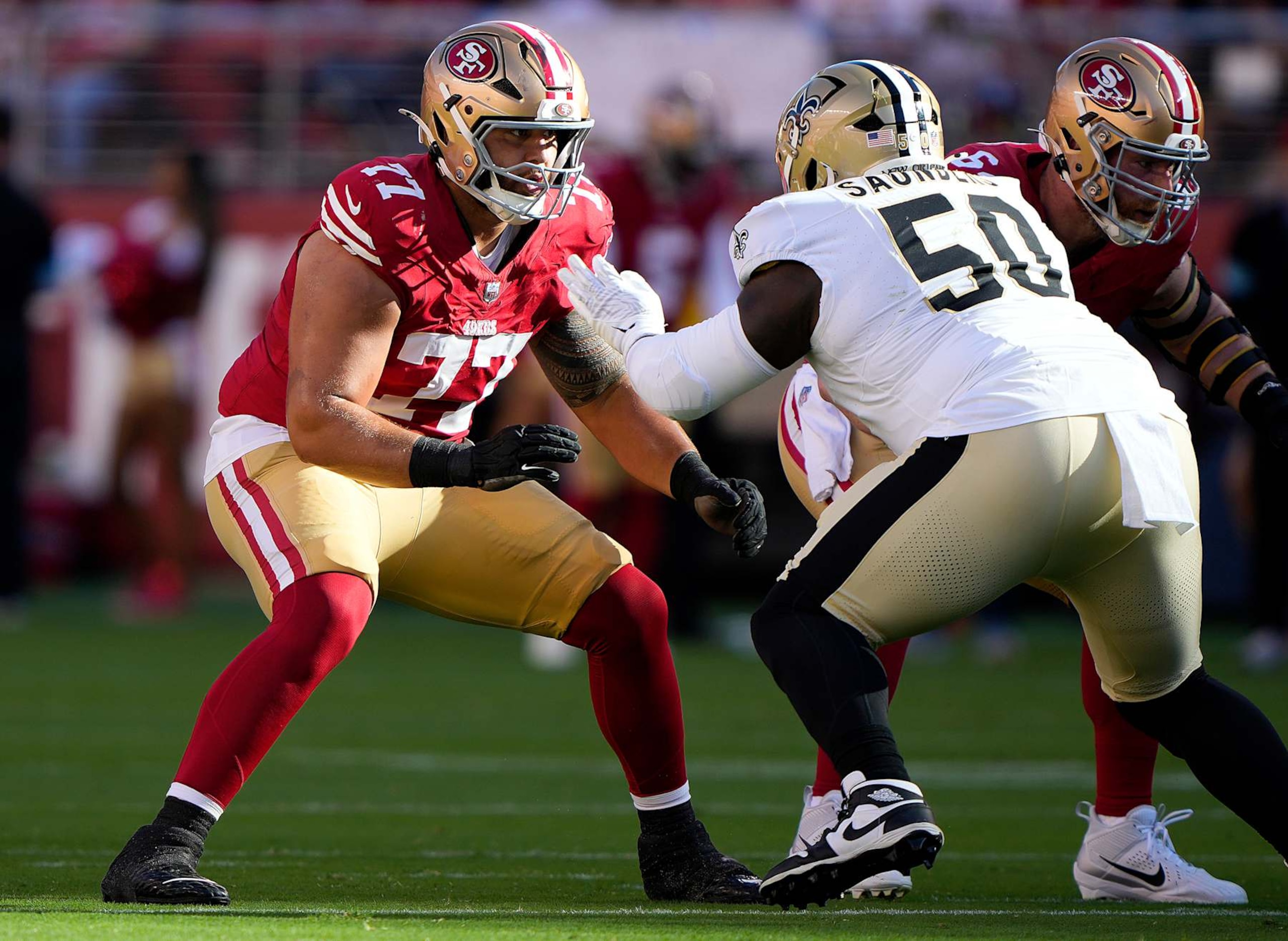 SANTA CLARA, CALIFORNIA - AUGUST 18: Dominick Puni #77 of the San Francisco 49ers pass blocks against Khalen Saunders #50 the New Orleans Saints during the first half of a preseason game at Levi's Stadium on August 18, 2024 in Santa Clara, California. (Photo by Thearon W. Henderson/Getty Images)