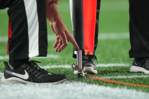 NFL Official Carted Off After Gruesome Leg Injury from Collision with Saints' Kamara