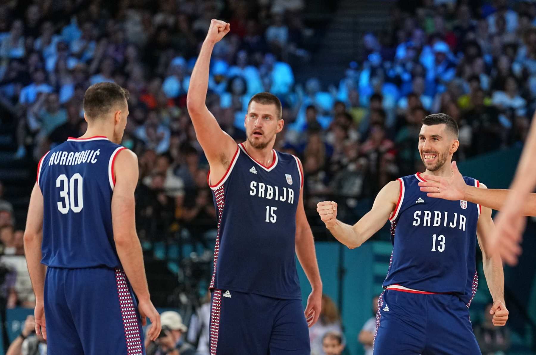 PARIS, FRANCE - AUGUST 10:   Nikola Jokic #15 of the Serbian Men's National Team Ognjen Dobric #13 of the Serbian Men's National Team celebrates during the game during the Mens Bronze Medal game at the  AccorHotels Arena on August 10, 2024 in Lille, France. NOTE TO USER: User expressly acknowledges and agrees that, by downloading and/or using this photograph, user is consenting to the terms and conditions of the Getty Images License Agreement. Mandatory Copyright Notice: Copyright 2024 NBAE (Photo by Garrett W. Ellwood/NBAE via Getty Images)