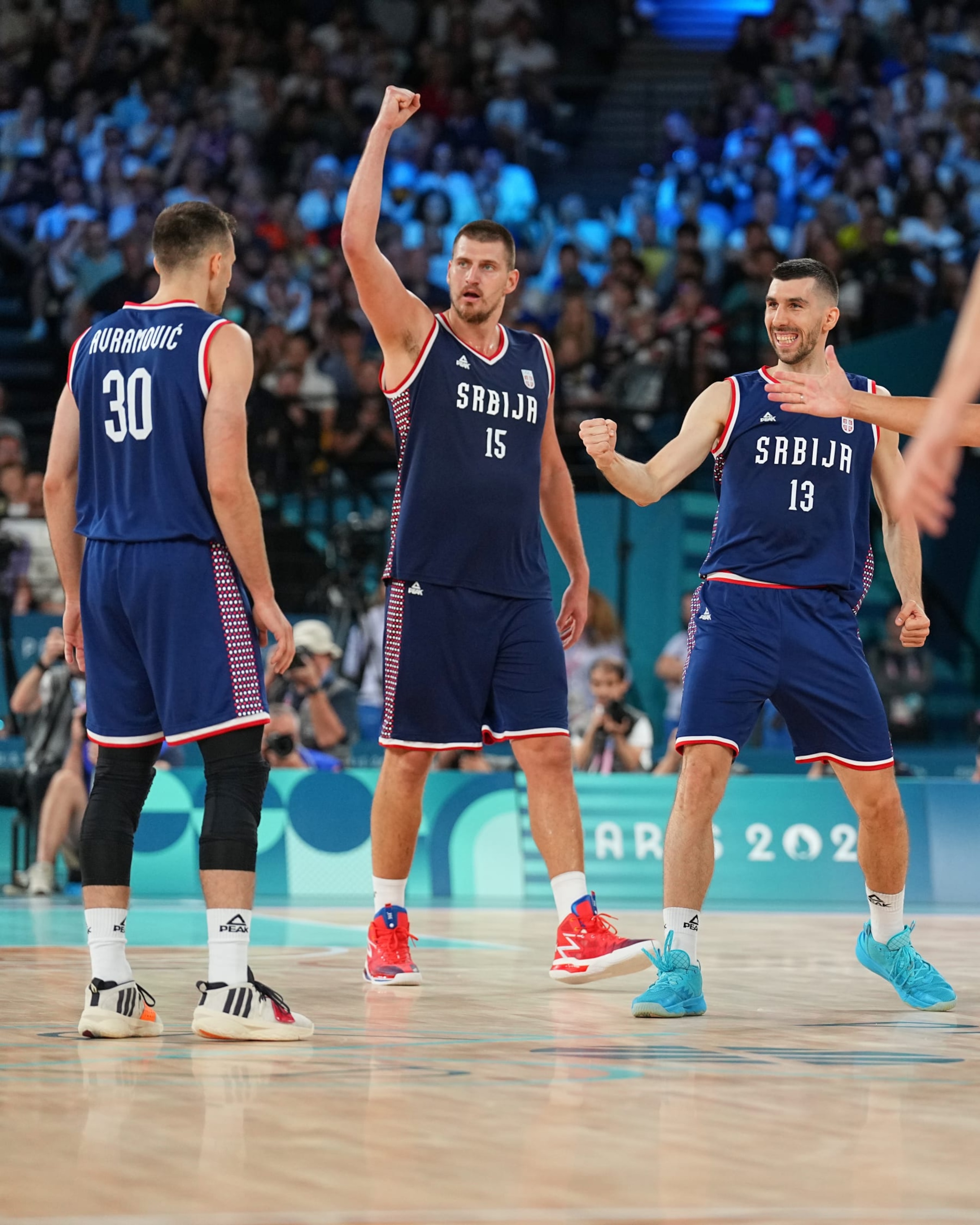 PARIS, FRANCE - AUGUST 10:   Nikola Jokic #15 of the Serbian Men's National Team Ognjen Dobric #13 of the Serbian Men's National Team celebrates during the game during the Mens Bronze Medal game at the  AccorHotels Arena on August 10, 2024 in Lille, France. NOTE TO USER: User expressly acknowledges and agrees that, by downloading and/or using this photograph, user is consenting to the terms and conditions of the Getty Images License Agreement. Mandatory Copyright Notice: Copyright 2024 NBAE (Photo by Garrett W. Ellwood/NBAE via Getty Images)