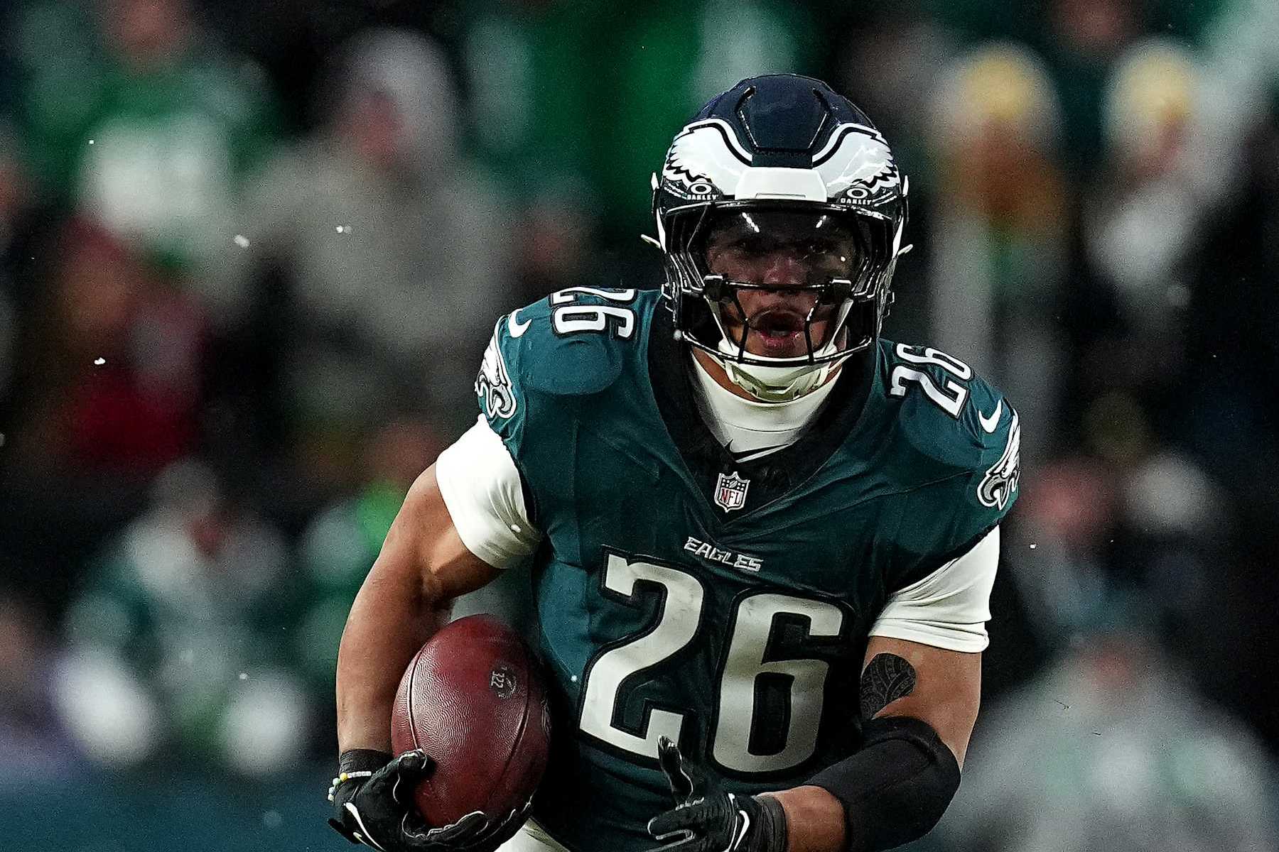 PHILADELPHIA, PENNSYLVANIA - JANUARY 19: Saquon Barkley #26 of the Philadelphia Eagles runs the ball for a 62-yard touchdown against the Los Angeles Rams during the first quarter in the NFC Divisional Playoff at Lincoln Financial Field on January 19, 2025 in Philadelphia, Pennsylvania. (Photo by Mitchell Leff/Getty Images)