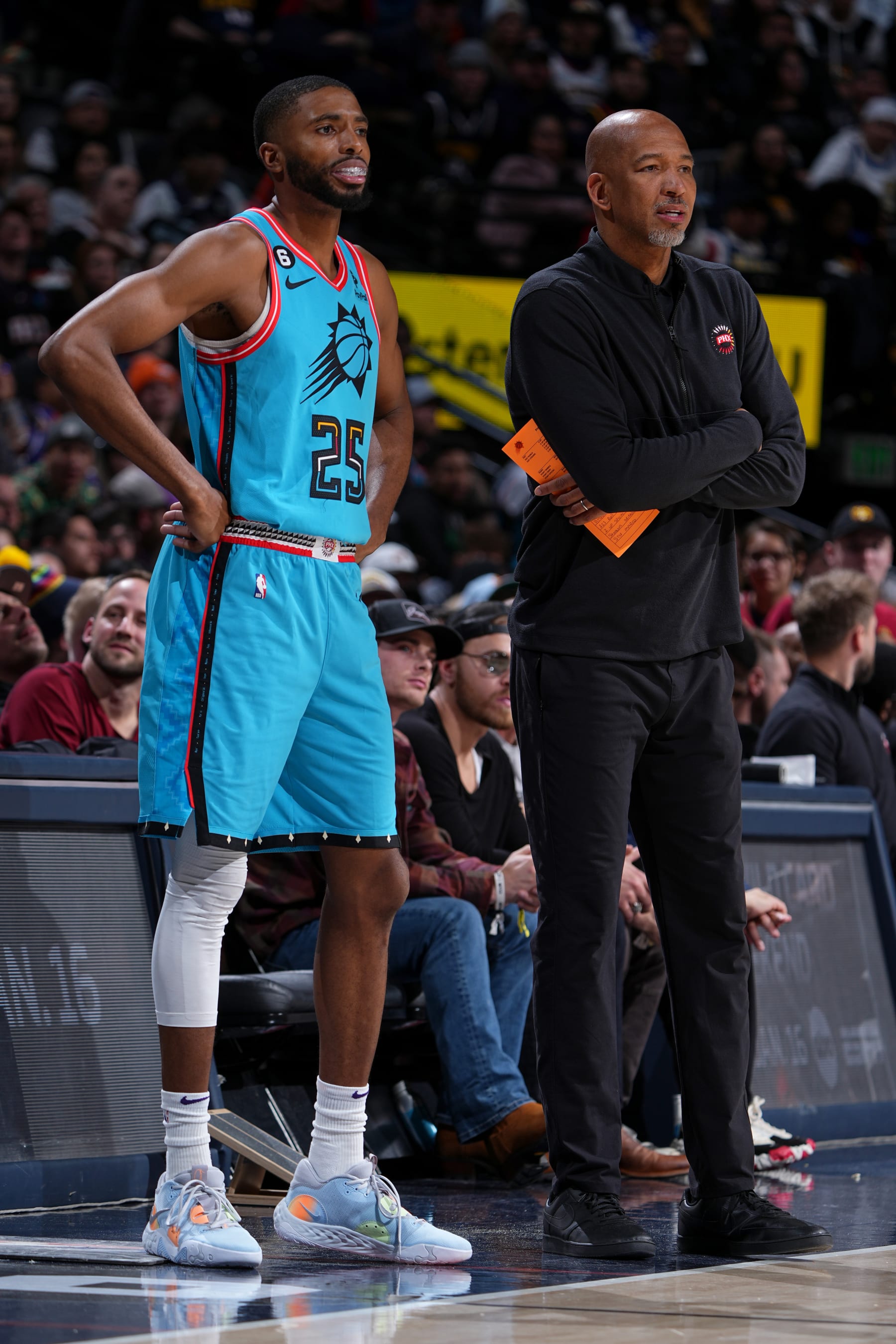 DENVER, CO - DECEMBER 25: Mikal Bridges #25 of the Phoenix Suns and Head Coach Monty Williams of the Phoenix Suns look on during the game against the Denver Nuggets on December 25, 2022 at the Ball Arena in Denver, Colorado. NOTE TO USER: User expressly acknowledges and agrees that, by downloading and/or using this Photograph, user is consenting to the terms and conditions of the Getty Images License Agreement. Mandatory Copyright Notice: Copyright 2022 NBAE (Photo by Garrett Ellwood/NBAE via Getty Images)