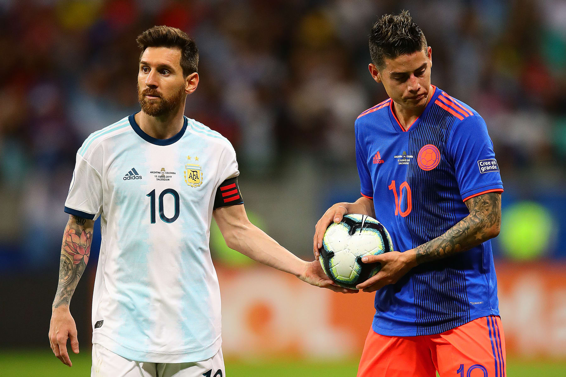 SALVADOR, BRAZIL - JUNE 15: Lionel Messi of Argentina hands the ball to James Rodriguez of Colombia during the Copa America Brazil 2019 group B match between Argentina and Colombia at Arena Fonte Nova on June 15, 2019 in Salvador, Brazil. (Photo by Chris Brunskill/Fantasista/Getty Images)