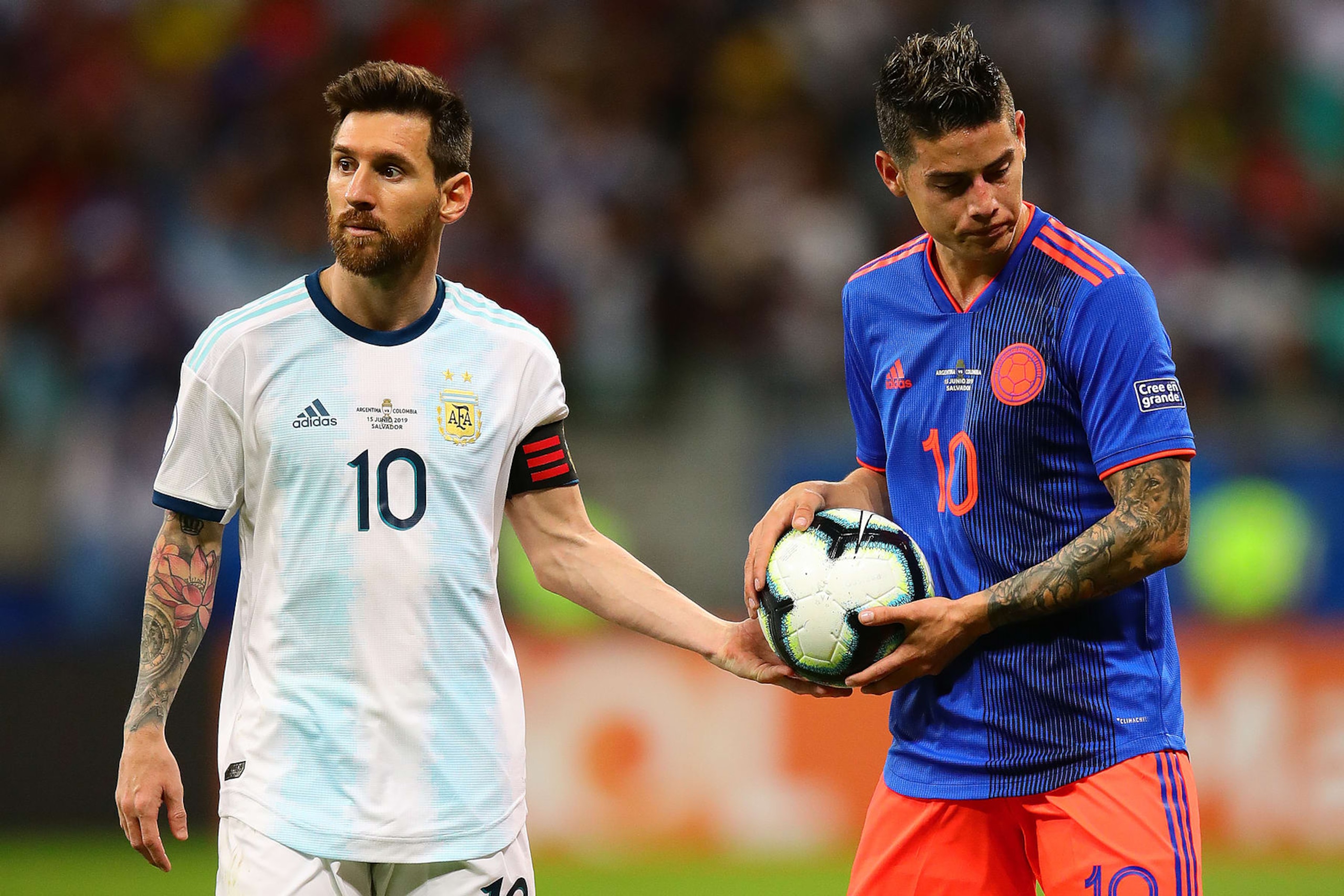 SALVADOR, BRAZIL - JUNE 15: Lionel Messi of Argentina hands the ball to James Rodriguez of Colombia during the Copa America Brazil 2019 group B match between Argentina and Colombia at Arena Fonte Nova on June 15, 2019 in Salvador, Brazil. (Photo by Chris Brunskill/Fantasista/Getty Images)