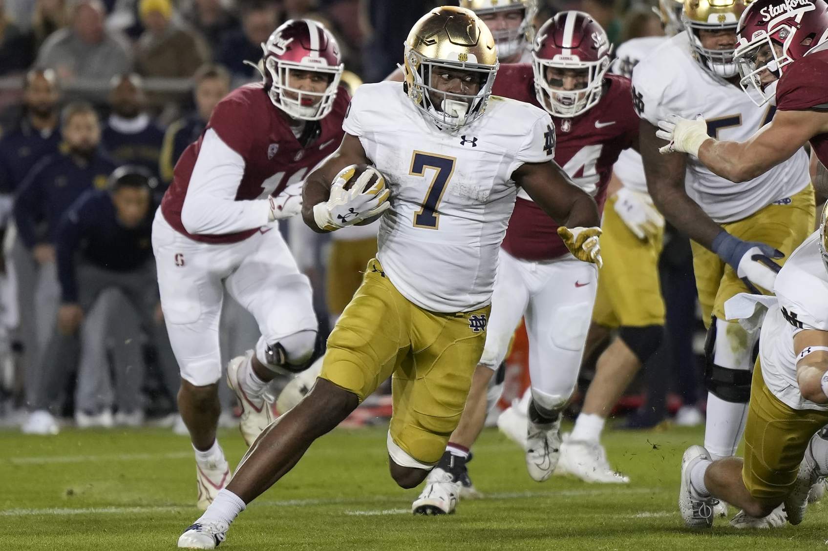 STANFORD, CALIFORNIA - NOVEMBER 25: Audric Estime #7 of the Notre Dame Fighting rushes for a six yard touchdown against the Stanford Cardinal during the second quarter at Stanford Stadium on November 25, 2023 in Stanford, California. (Photo by Thearon W. Henderson/Getty Images)