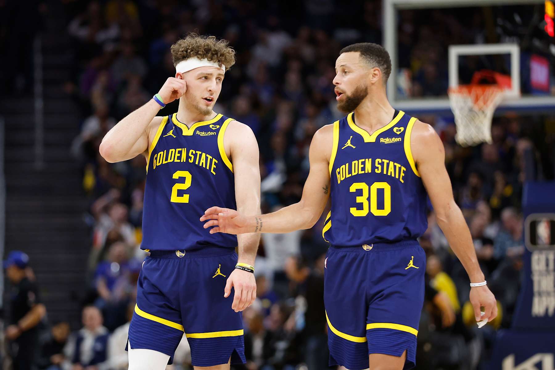 SAN FRANCISCO, CALIFORNIA - FEBRUARY 22: Stephen Curry #30 of the Golden State Warriors talks to teammate Brandin Podziemski #2 in the first half against the Los Angeles Lakers at Chase Center on February 22, 2024 in San Francisco, California. NOTE TO USER: User expressly acknowledges and agrees that, by downloading and or using this photograph, User is consenting to the terms and conditions of the Getty Images License Agreement. (Photo by Lachlan Cunningham/Getty Images)