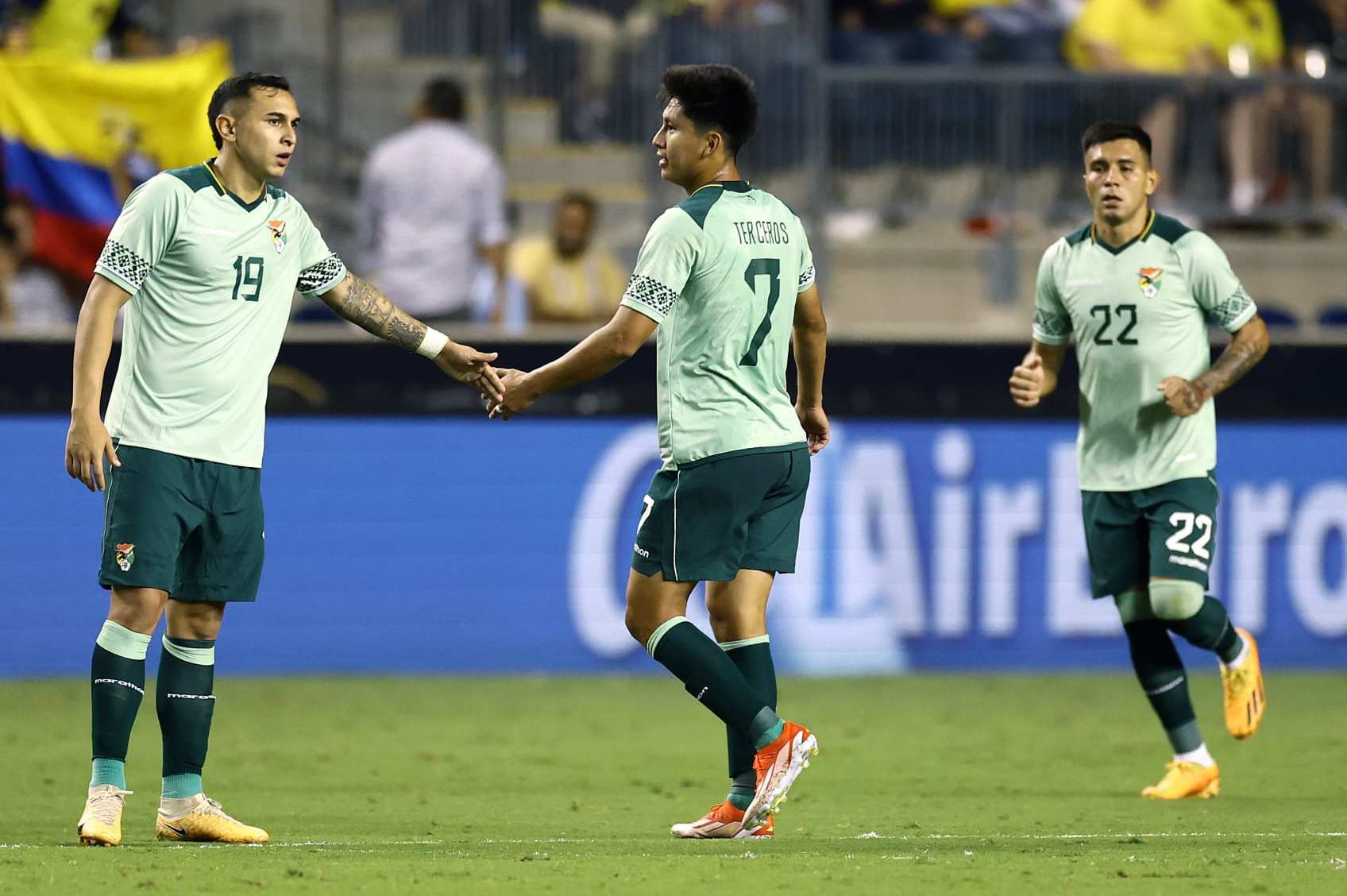 CHESTER, PENNSYLVANIA - JUNE 12: Bruno Miranda #19 and Miguel Terceros #7 of Bolivia react following a goal scored by Terceros during the second half against Ecuador at Subaru Park on June 12, 2024 in Chester, Pennsylvania. (Photo by Tim Nwachukwu/Getty Images)
