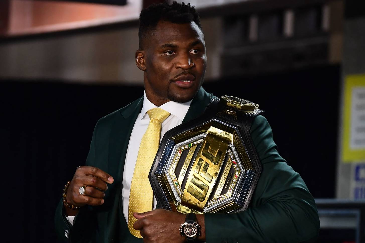 Champion Cameroon's Francis Ngannou holds the championship belt in the press room after defeating French Cyril Gane in their UFC 270 championship fight in Anaheim on January 22, 2022. (Photo by Frederic J. BROWN / AFP) (Photo by FREDERIC J. BROWN/AFP via Getty Images)