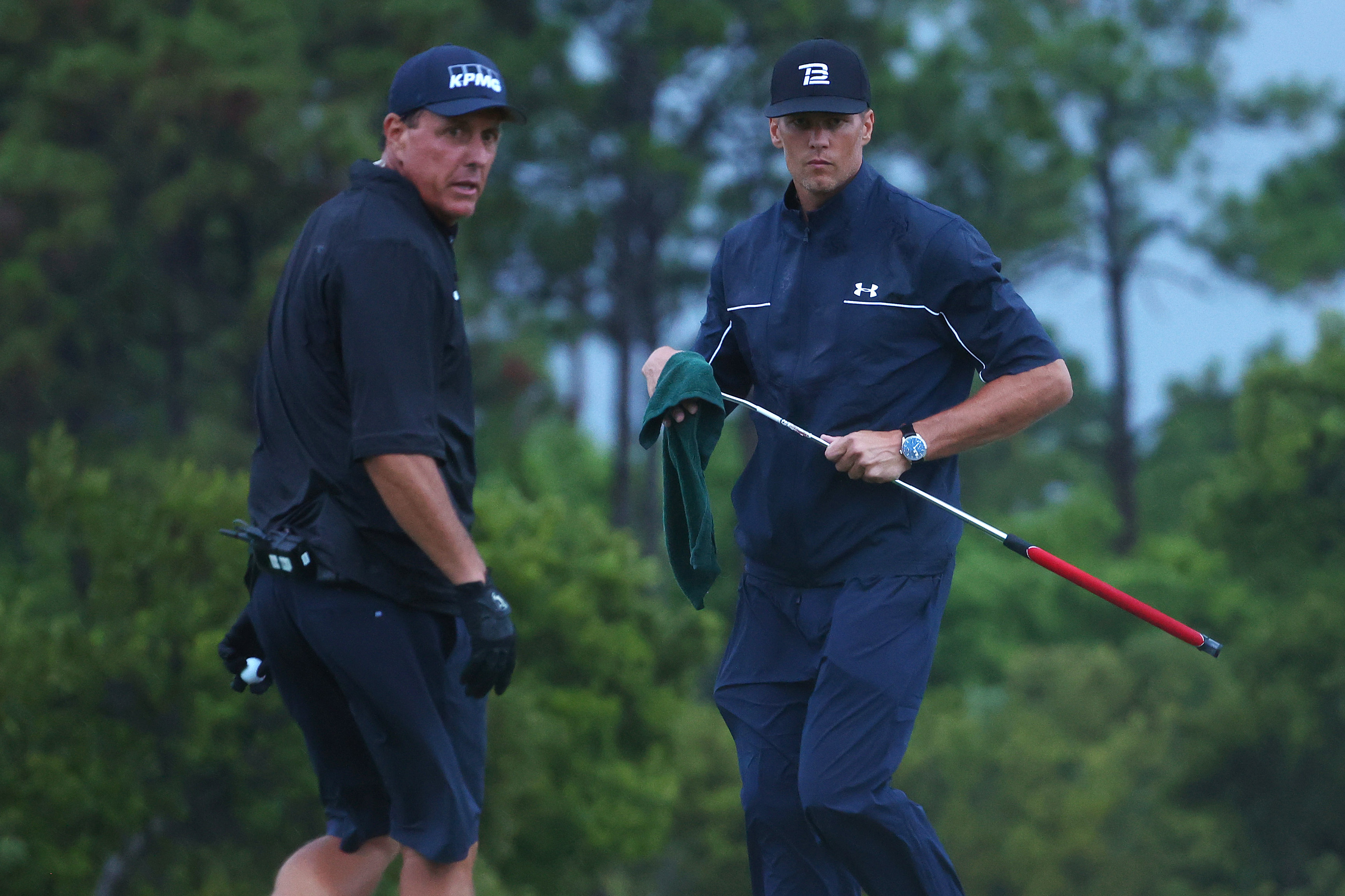 HOBE SOUND, FLORIDA - MAY 24:  Phil Mickelson reads a putt for NFL player Tom Brady of the Tampa Bay Buccaneers looks on the 17th green during The Match: Champions For Charity at Medalist Golf Club on May 24, 2020 in Hobe Sound, Florida. (Photo by Mike Ehrmann/Getty Images for The Match)