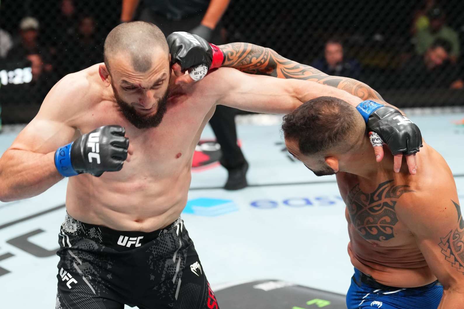 DENVER, COLORADO - JULY 13: (R-L) Santiago Ponzinibbio of Argentina punches Muslim Salikhov of Russia in a welterweight fight during the UFC Fight Night event at Ball Arena on July 13, 2024 in Denver, Colorado. (Photo by Josh Hedges/Zuffa LLC via Getty Images)