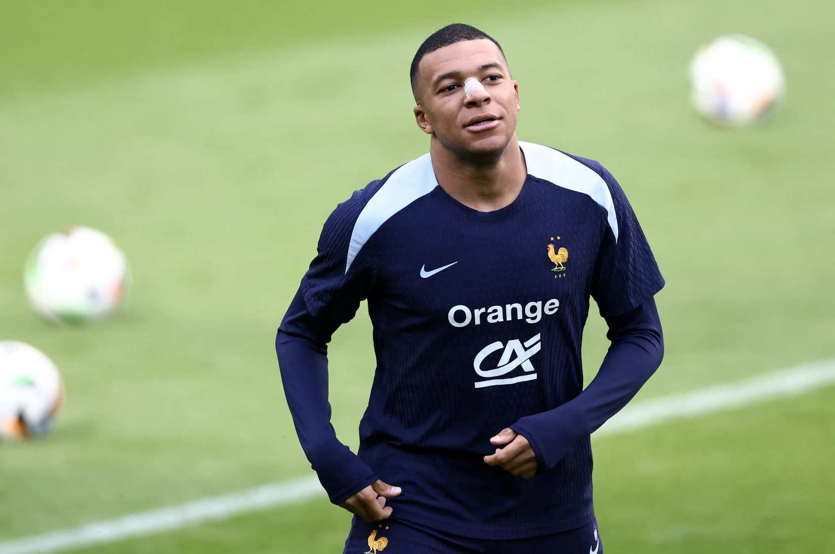 TOPSHOT - France's forward #10 Kylian Mbappe, who broke his nose during his country's opening win against Austria, attends a training session during the UEFA Euro 2024 Football Championship, at the Home Deluxe Arena Stadium in Paderborn, western Germany, on June 19, 2024. Mbappe underwent tests at a hospital in Duesseldorf before rejoining the France squad at their base in Paderborn. (Photo by FRANCK FIFE / AFP) (Photo by FRANCK FIFE/AFP via Getty Images)