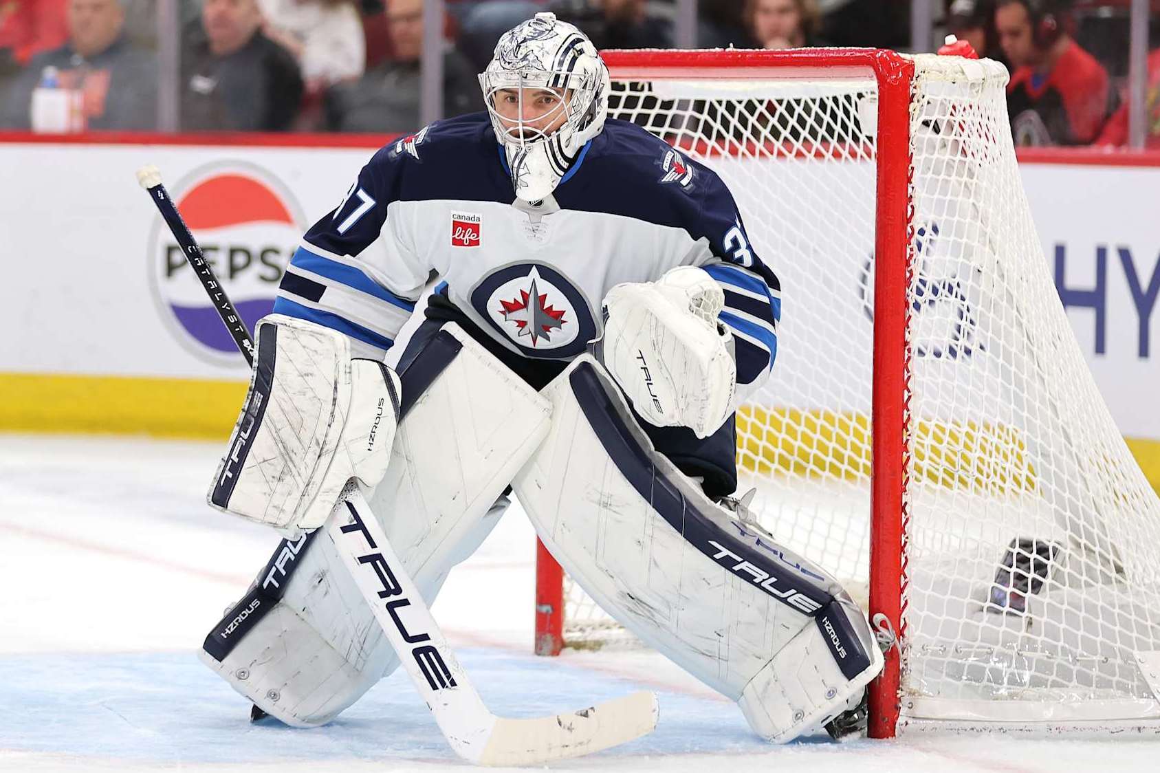 CHICAGO, ILLINOIS - DECEMBER 07: Connor Hellebuyck #37 of the Winnipeg Jets tends the net against the Chicago Blackhawks during the second period at the United Center on December 07, 2024 in Chicago, Illinois. (Photo by Michael Reaves/Getty Images)