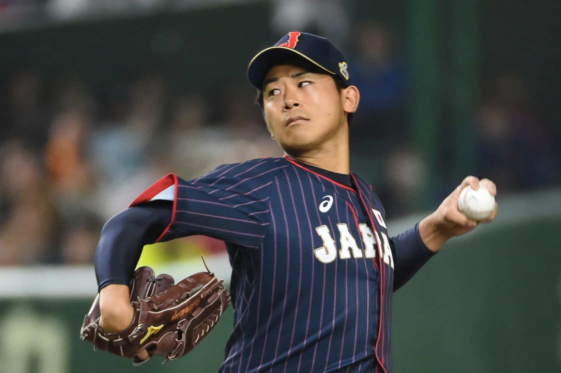 Japan's starting pitcher Shota Imanaga pitches against Taiwan in the first inning during the Asia Professional Baseball Championships preliminary round match between Japan and Taiwan at the Tokyo Dome in Tokyo on November 18, 2017. / AFP PHOTO / Kazuhiro NOGI (Photo credit should read KAZUHIRO NOGI/AFP via Getty Images)