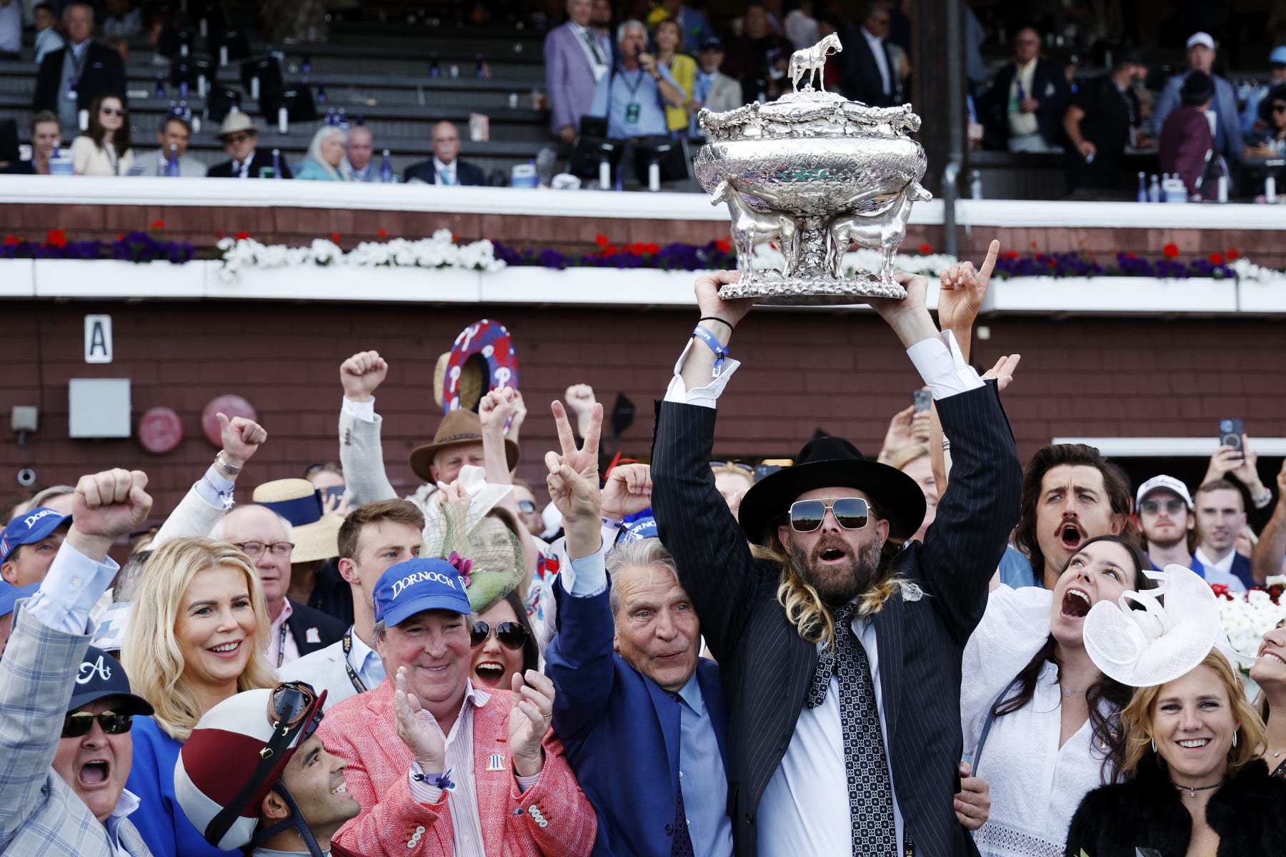 SARATOGA SPRINGS, NEW YORK - JUNE 08: Owner Jayson Werth (C) raises the trophy after Dornoch with Luis Saez up wins the 156th running of the Belmont Stakes at Saratoga Race Course on June 08, 2024 in Saratoga Springs, New York.  The race was moved to Saratoga while Belmont Park undergoes renovations. (Photo by Sarah Stier/Getty Images)