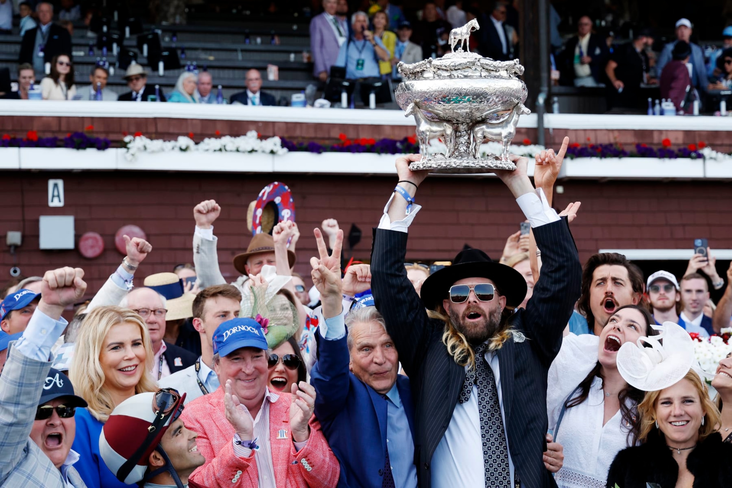 SARATOGA SPRINGS, NEW YORK - JUNE 08: Owner Jayson Werth (C) raises the trophy after Dornoch with Luis Saez up wins the 156th running of the Belmont Stakes at Saratoga Race Course on June 08, 2024 in Saratoga Springs, New York.  The race was moved to Saratoga while Belmont Park undergoes renovations. (Photo by Sarah Stier/Getty Images)