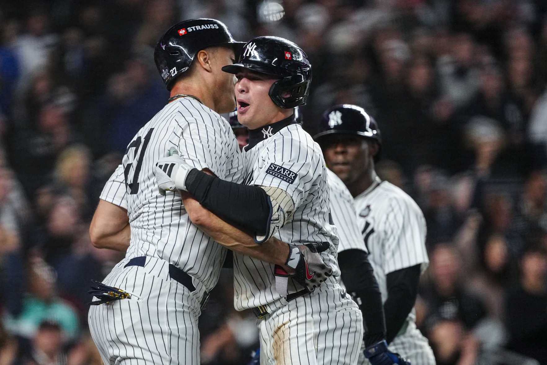 NEW YORK, NY - OCTOBER 29: Giancarlo Stanton #27 and Anthony Volpe #11 of the New York Yankees celebrate after Volpe's grand slam in the third inning of Game 4 of the 2024 World Series presented by Capital One between the Los Angeles Dodgers and the New York Yankees at Yankee Stadium on Tuesday, October 29, 2024 in New York, New York. (Photo by Mary DeCicco/MLB Photos via Getty Images)