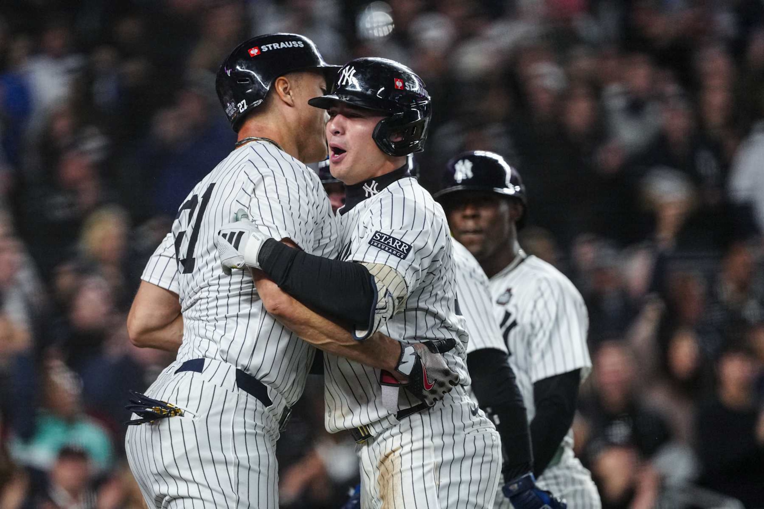 NEW YORK, NY - OCTOBER 29: Giancarlo Stanton #27 and Anthony Volpe #11 of the New York Yankees celebrate after Volpe's grand slam in the third inning of Game 4 of the 2024 World Series presented by Capital One between the Los Angeles Dodgers and the New York Yankees at Yankee Stadium on Tuesday, October 29, 2024 in New York, New York. (Photo by Mary DeCicco/MLB Photos via Getty Images)