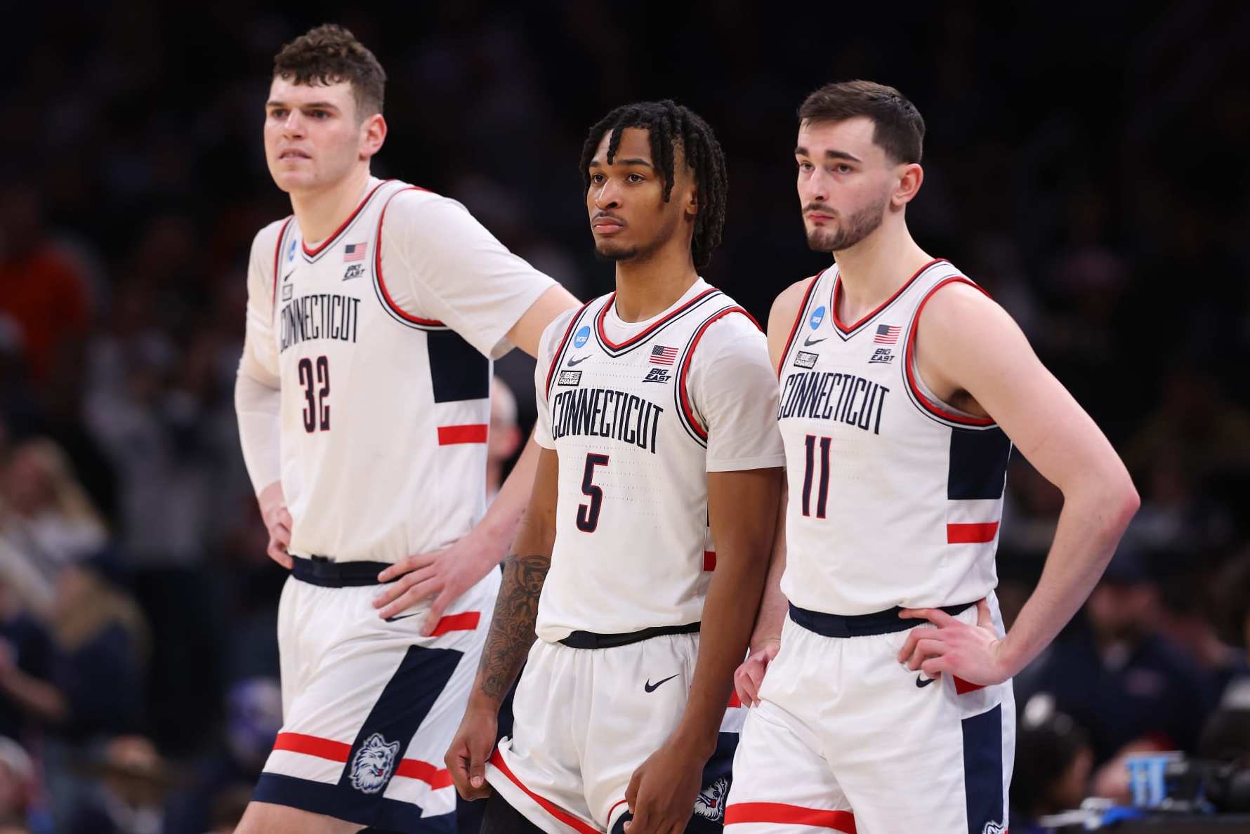 BOSTON, MASSACHUSETTS - MARCH 30: Donovan Clingan #32, Stephon Castle #5 and Alex Karaban #11 of the Connecticut Huskies look on against the Illinois Fighting Illini during the second half in the Elite 8 round of the NCAA Men's Basketball Tournament at TD Garden on March 30, 2024 in Boston, Massachusetts. (Photo by Michael Reaves/Getty Images)