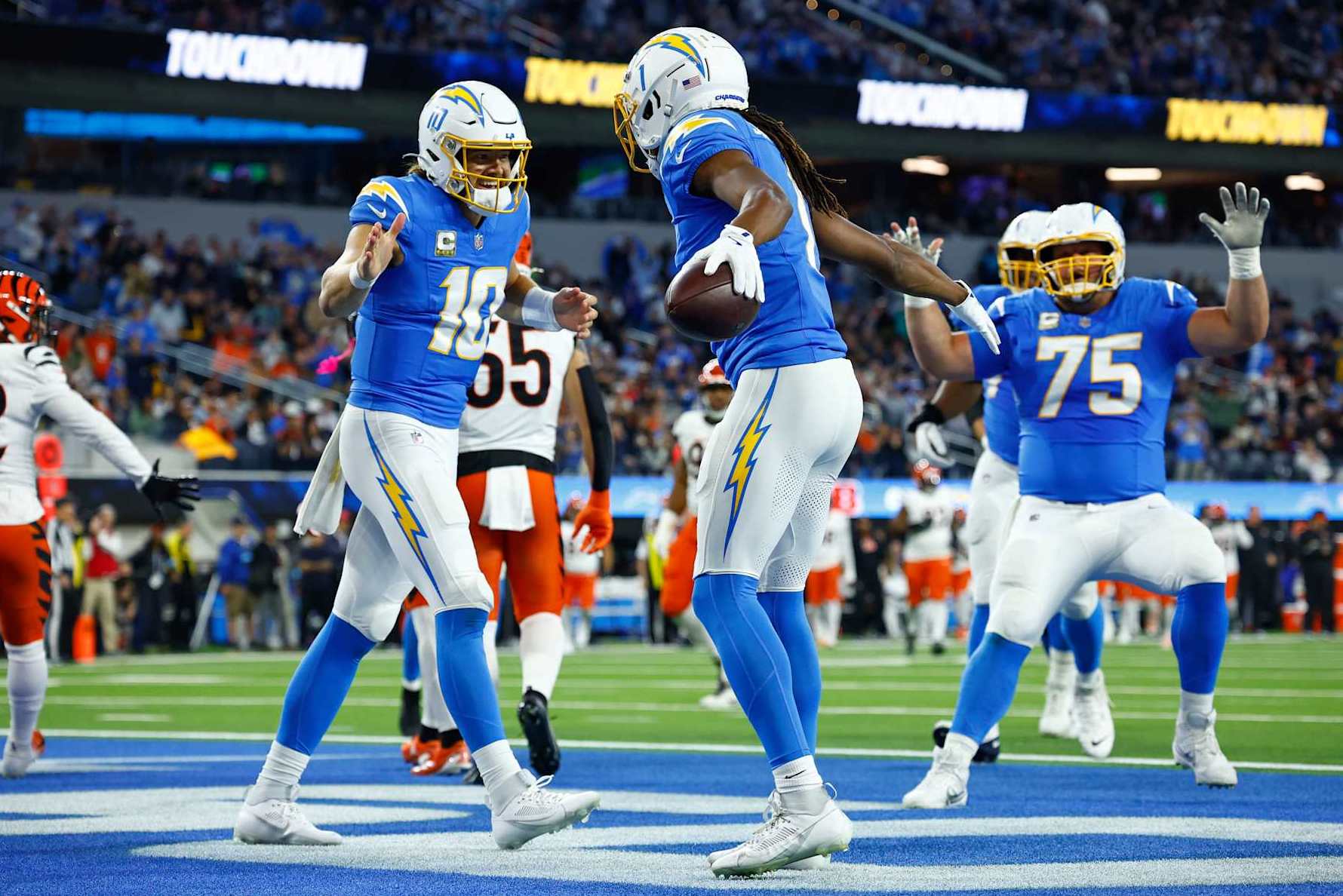 INGLEWOOD, CALIFORNIA - NOVEMBER 17: Justin Herbert #10 and Quentin Johnston #1 of the Los Angeles Chargers celebrate their touchdown connection against the Cincinnati Bengals during the second quarter at SoFi Stadium on November 17, 2024 in Inglewood, California. (Photo by Ronald Martinez/Getty Images)