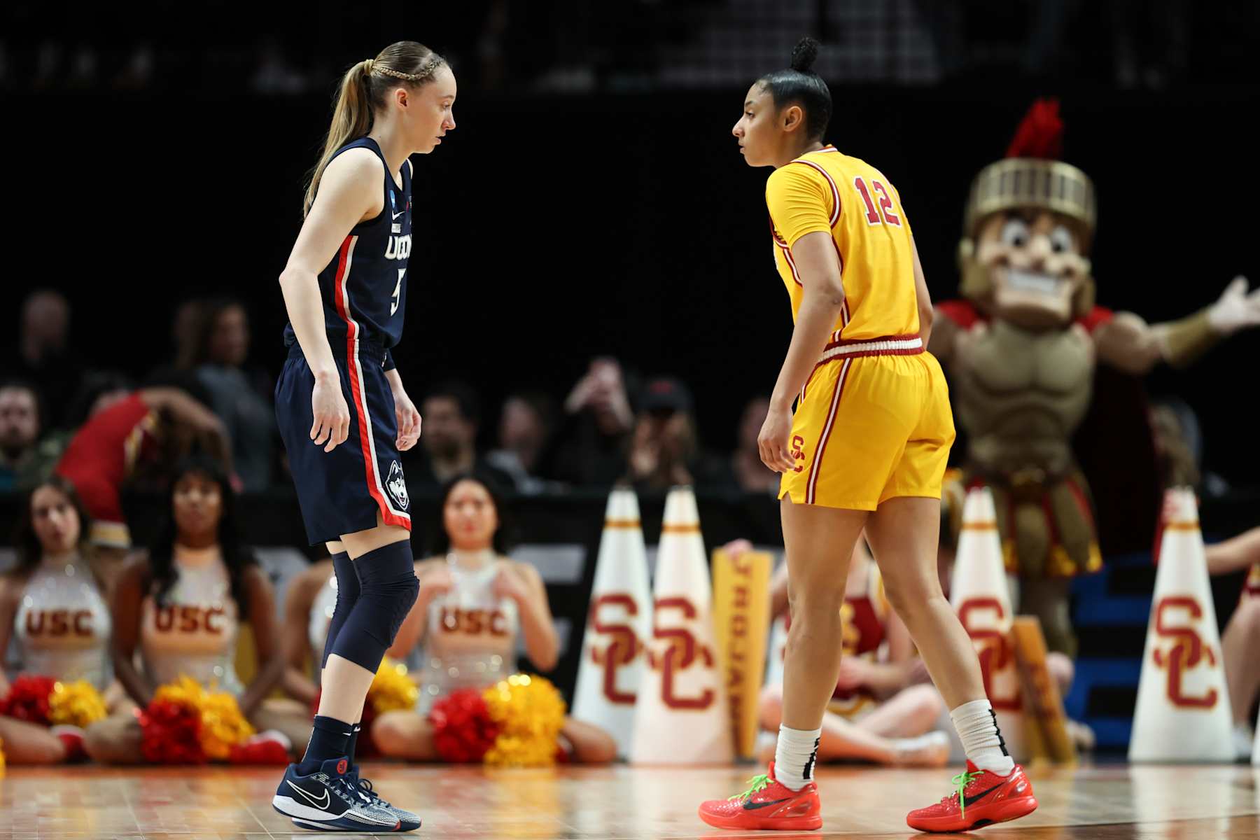 PORTLAND, OREGON - APRIL 01: Paige Bueckers #5 of the Connecticut Huskies and JuJu Watkins #12 of the USC Trojans looks on during the second half in the Elite 8 round of the NCAA Women's Basketball Tournament at Moda Center on April 01, 2024 in Portland, Oregon. (Photo by Steph Chambers/Getty Images)