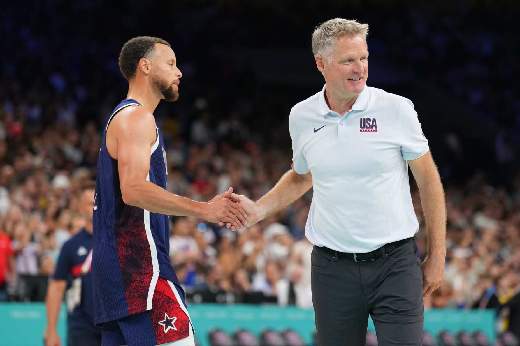LILLE, FRANCE - JULY 28: Stephen Curry #4 and Head Coach Steve Kerr of the USA Basketball Men's Team high five during the game against the Serbian Men's National Team on July 28, 2024 at the Stade Pierre Mauroy in Paris, France. NOTE TO USER: User expressly acknowledges and agrees that, by downloading and/or using this photograph, user is consenting to the terms and conditions of the Getty Images License Agreement. Mandatory Copyright Notice: Copyright 2024 NBAE (Photo by Jesse D. Garrabrant/NBAE via Getty Images)