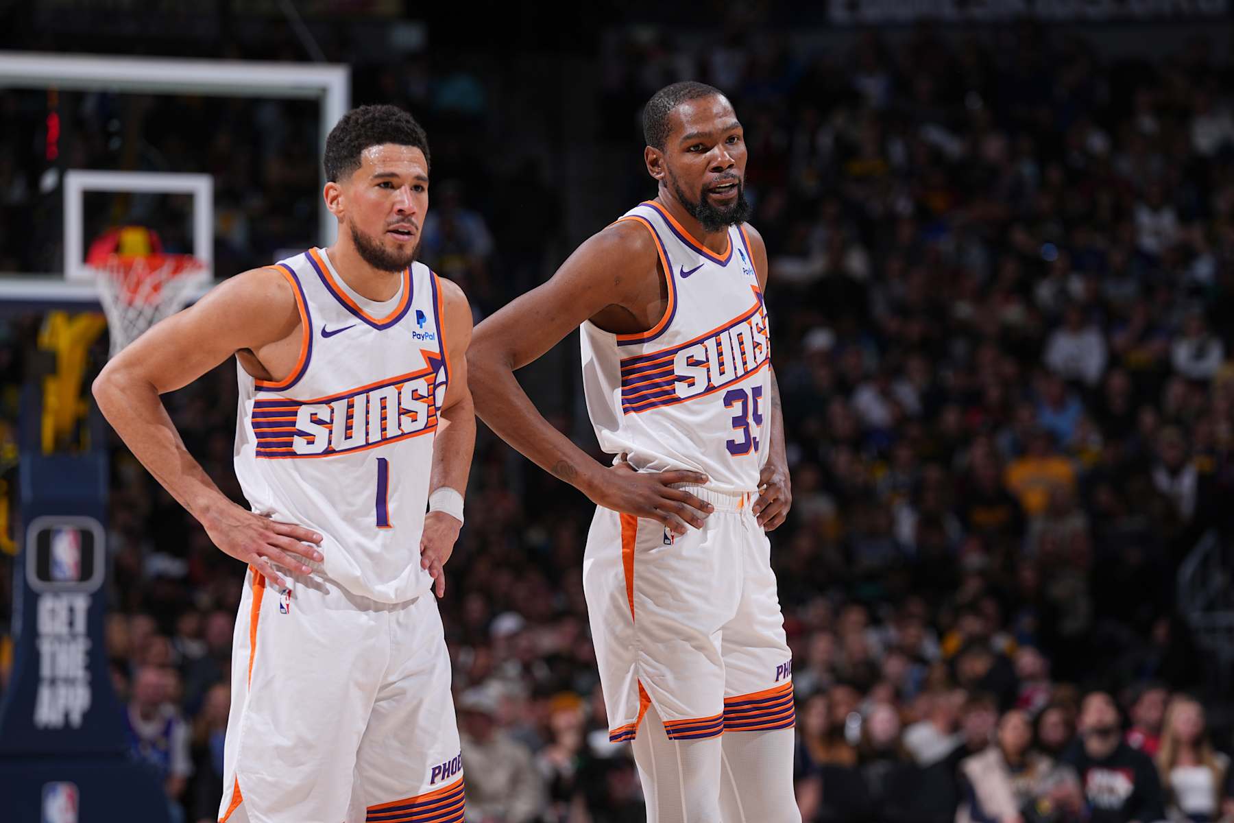 DENVER, CO - MARCH 27: Devin Booker #1 of the Phoenix Suns & Kevin Durant #35 of the Phoenix Suns looks on during the game on March 27, 2024 at the Ball Arena in Denver, Colorado. NOTE TO USER: User expressly acknowledges and agrees that, by downloading and/or using this Photograph, user is consenting to the terms and conditions of the Getty Images License Agreement. Mandatory Copyright Notice: Copyright 2024 NBAE (Photo by Bart Young/NBAE via Getty Images)