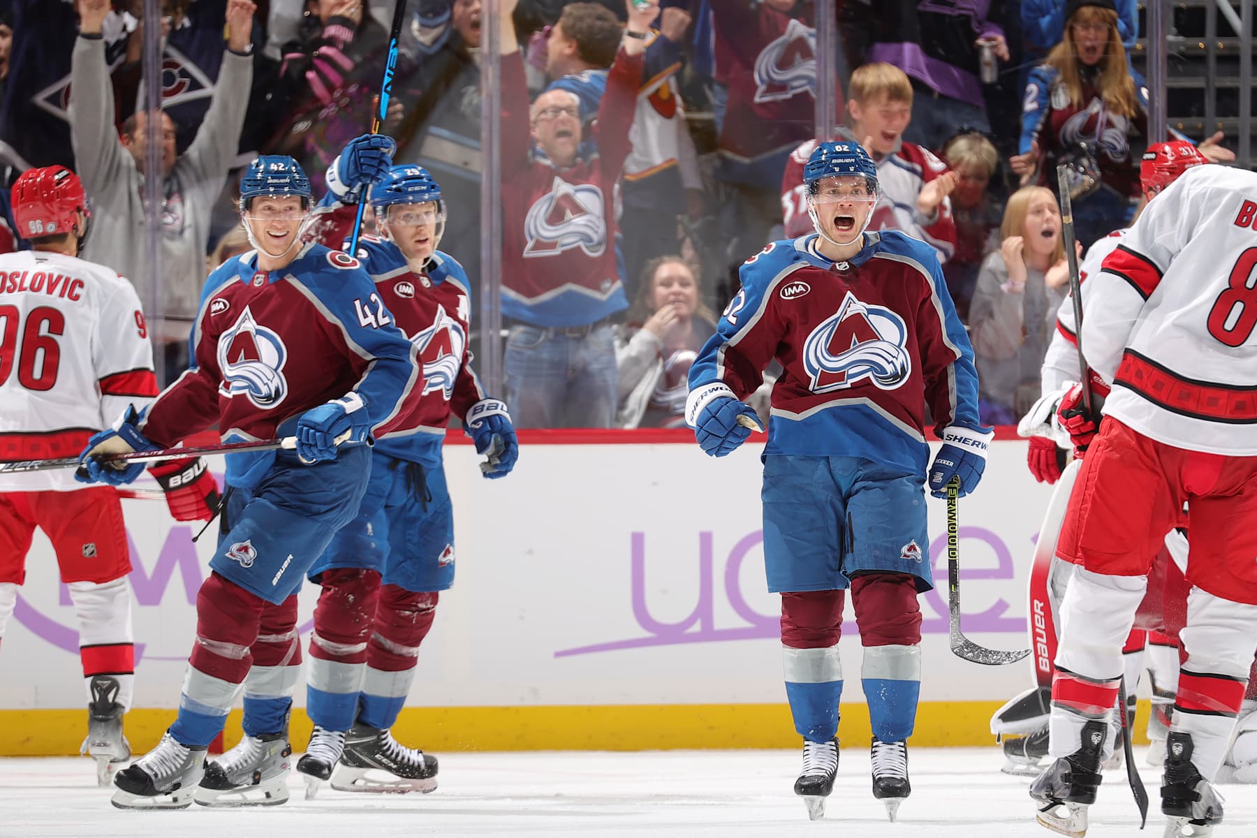 DENVER, COLORADO - NOVEMBER 09: Josh Manson #42, Nathan MacKinnon #29 and Artturi Lehkonen #62 of the Colorado Avalanche celebrate a goal against the Carolina Hurricanes at Ball Arena on November 9, 2024 in Denver, Colorado. (Photo by Michael Martin/NHLI via Getty Images)