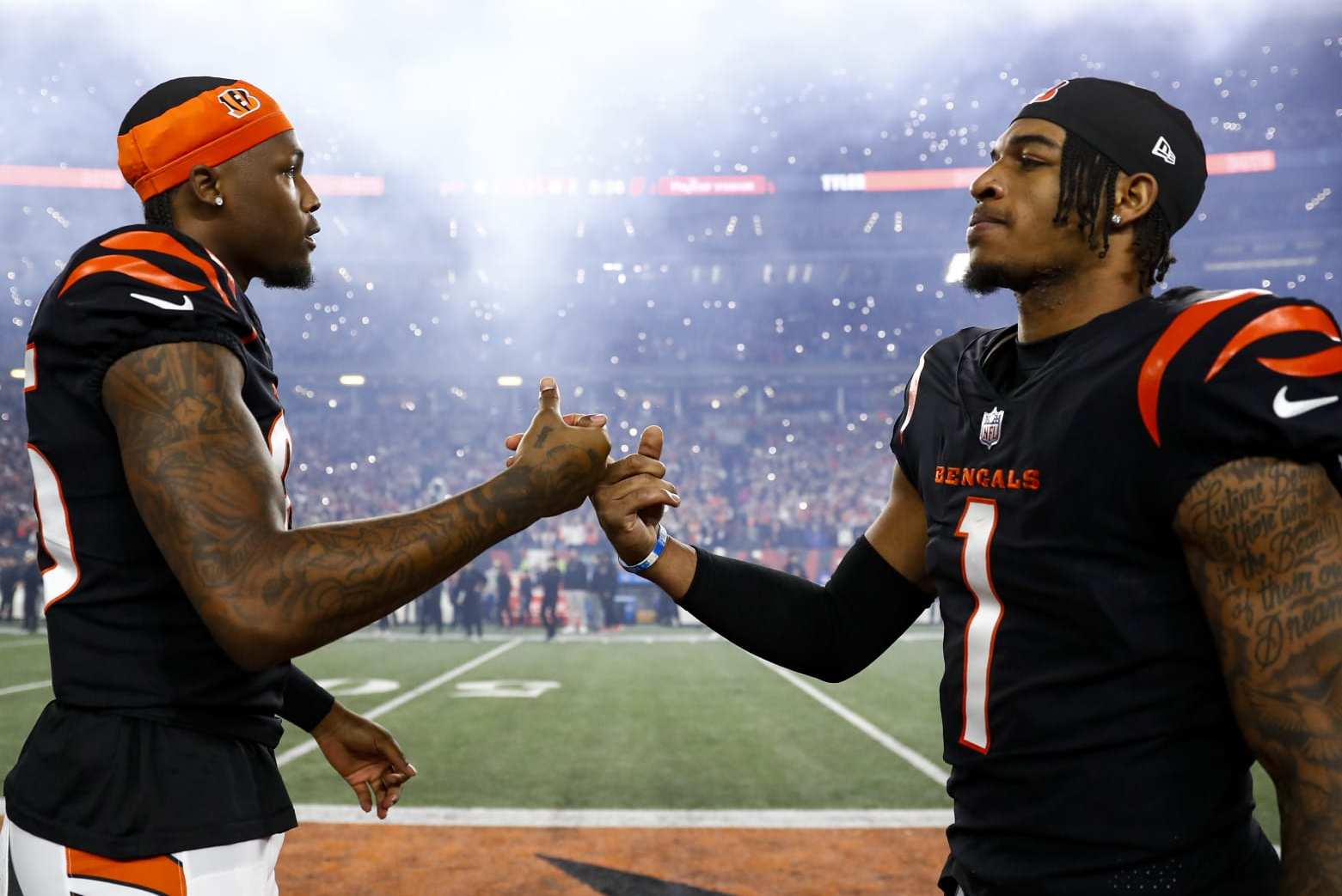 CINCINNATI, OH - JANUARY 2: Tee Higgins #85 of the Cincinnati Bengals high fives Ja'Marr Chase #1 on the field prior to an NFL football game against the Buffalo Bills at Paycor Stadium on January 2, 2023 in Cincinnati, Ohio. (Photo by Kevin Sabitus/Getty Images)