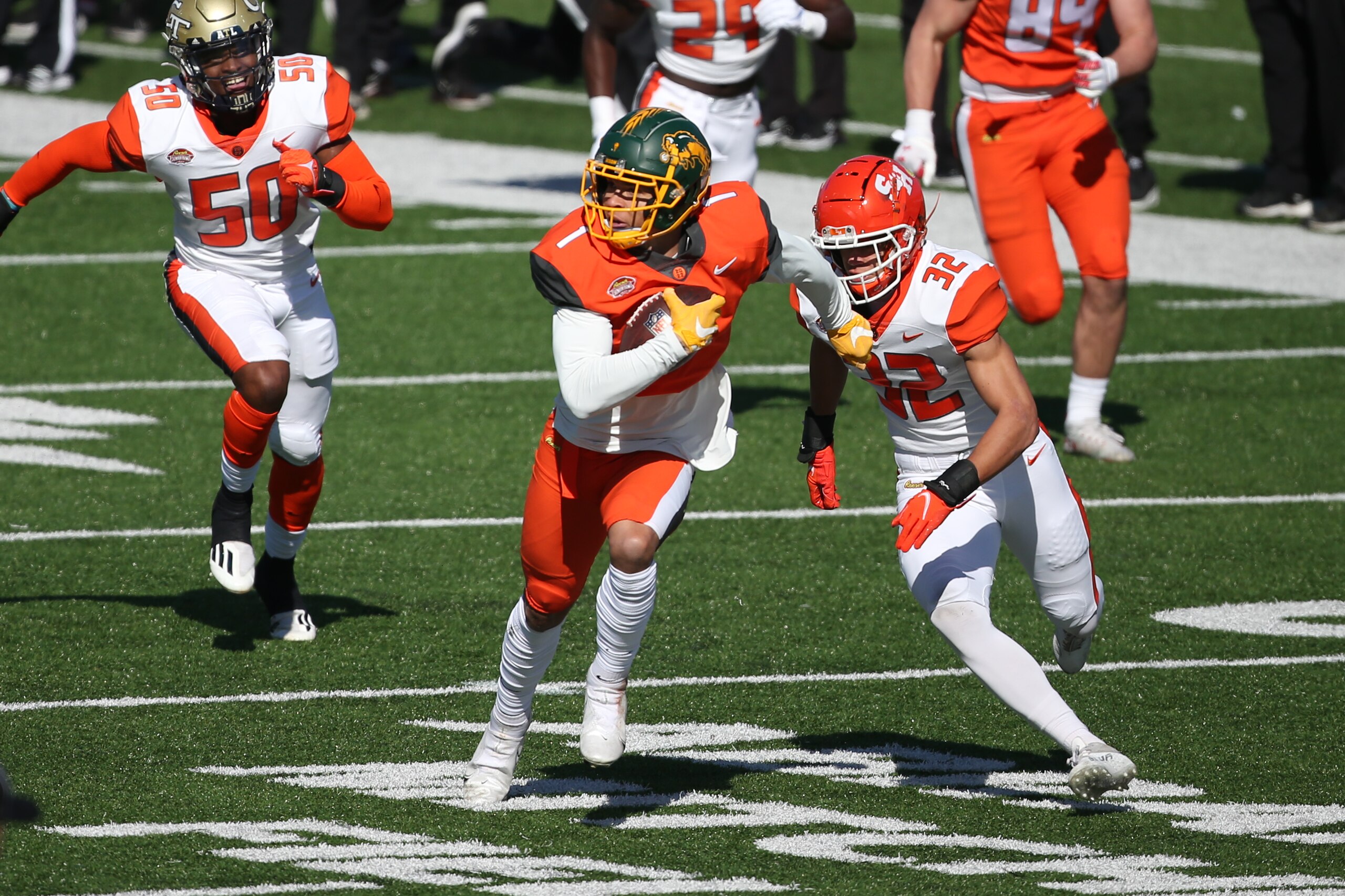 MOBILE, AL - FEBRUARY 05: National wide receiver Christian Watson of North Dakota State (1) carries ball downfield as he is pursued by American defensive back Zyon McCollum of Sam Houston State (32)during the Reese's Senior Bowl on February 5, 2022 at Hancock Whitney Stadium in Mobile, Alabama.  (Photo by Michael Wade/Icon Sportswire via Getty Images)