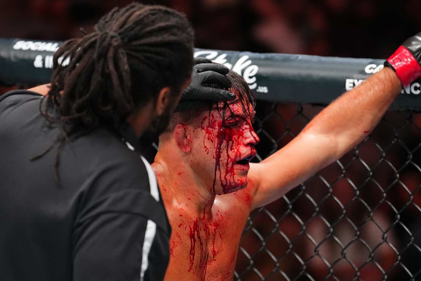 DENVER, COLORADO - JULY 13: Referee Herb Dean looks at Drew Dober's cut in a lightweight fight against Jean Silva of Brazil during the UFC Fight Night event at Ball Arena on July 13, 2024 in Denver, Colorado. (Photo by Josh Hedges/Zuffa LLC via Getty Images)