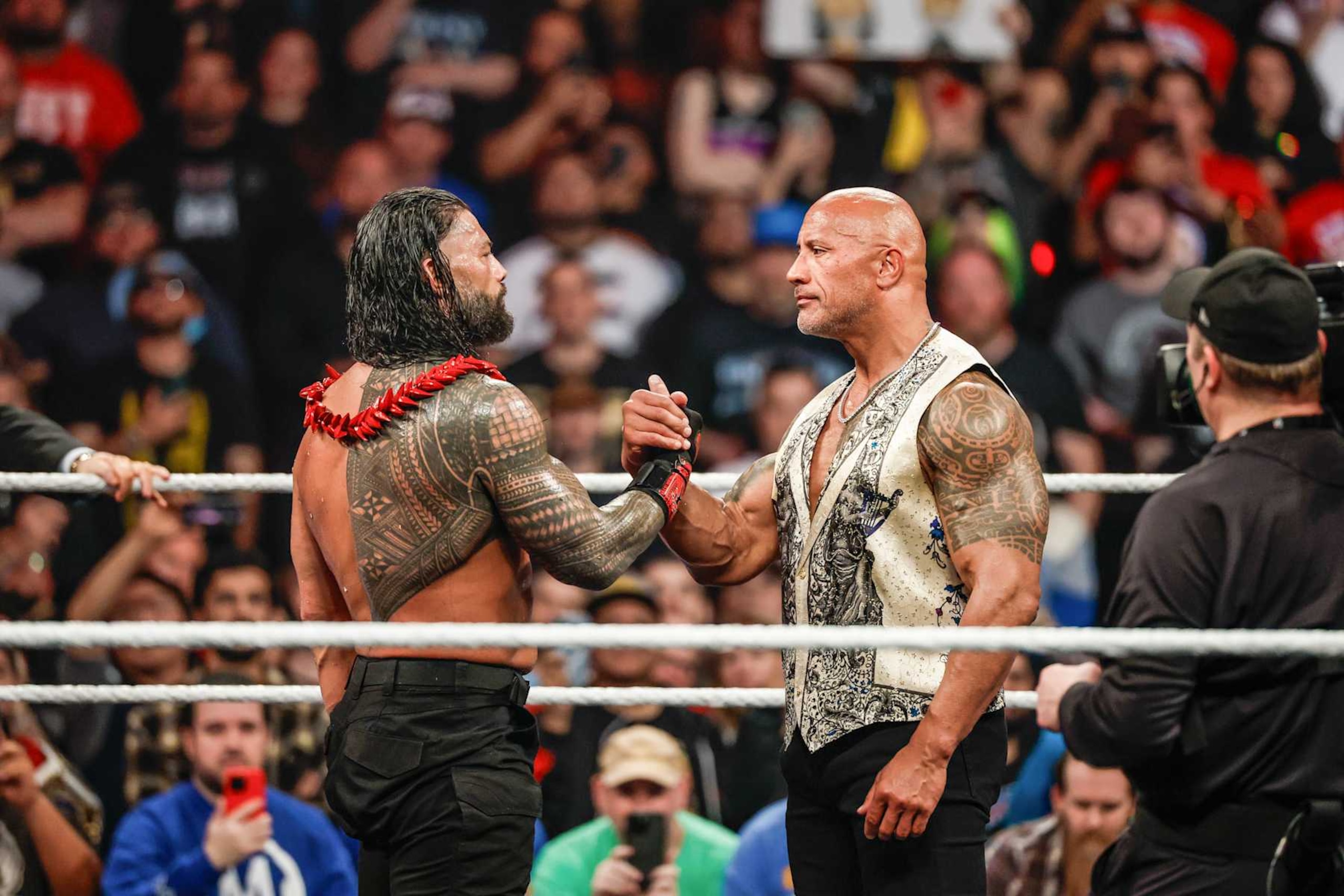 INGLEWOOD, CALIFORNIA - JANUARY 6: Roman Reigns and Dwayne "The Rock" Johnson embrace during RAW at Intuit Dome on January 6, 2025 in Inglewood, California.  (Photo by WWE/Getty Images)