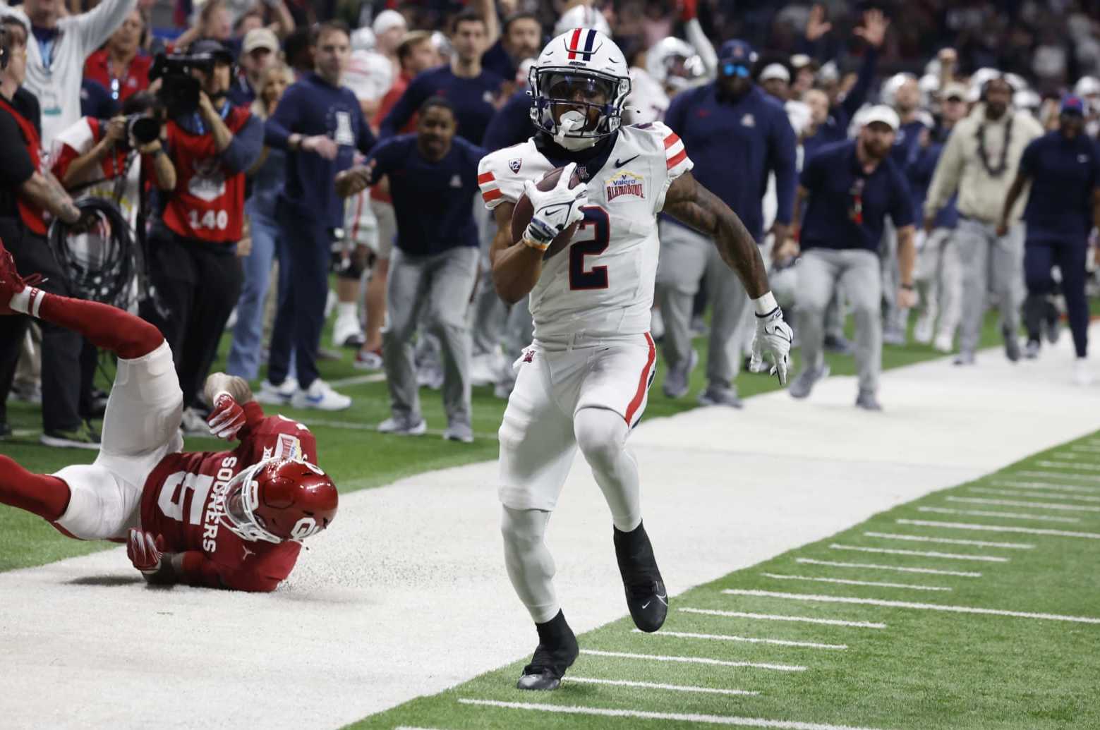 SAN ANTONIO, TX - DECEMBER 28:  Jacob Cowing #2 of the Arizona Wildcats scorers a touchdown in the second half at the Valero Alamo Bowl at the Alamodome on December  28, 2023 in San Antonio, Texas.  (Photo by Ronald Cortes/Getty Images)