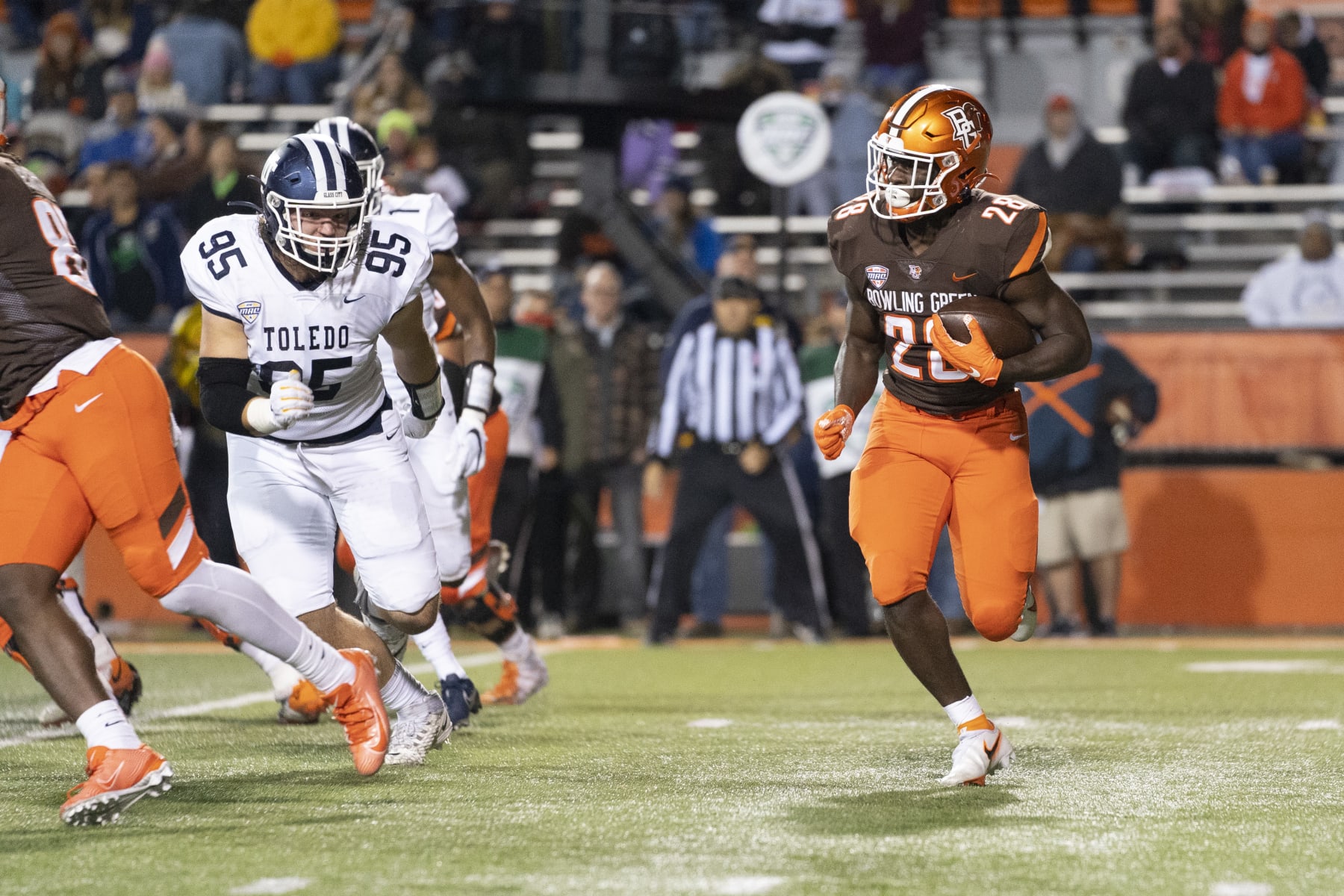 BOWLING GREEN, OH - NOVEMBER 10: Bowling Green Falcons Running Back Jaison Patterson (28) runs with the ball with Toledo Rockets Defensive Tackle Judge Culpepper (95) in pursuit during the first half of the College Football game between the Toledo Rockets and the Bowling Green Falcons on November 10, 2021, at Doyt Perry Stadium in Bowling Green, OH. (Photo by Gregory Fisher/Icon Sportswire via Getty Images)