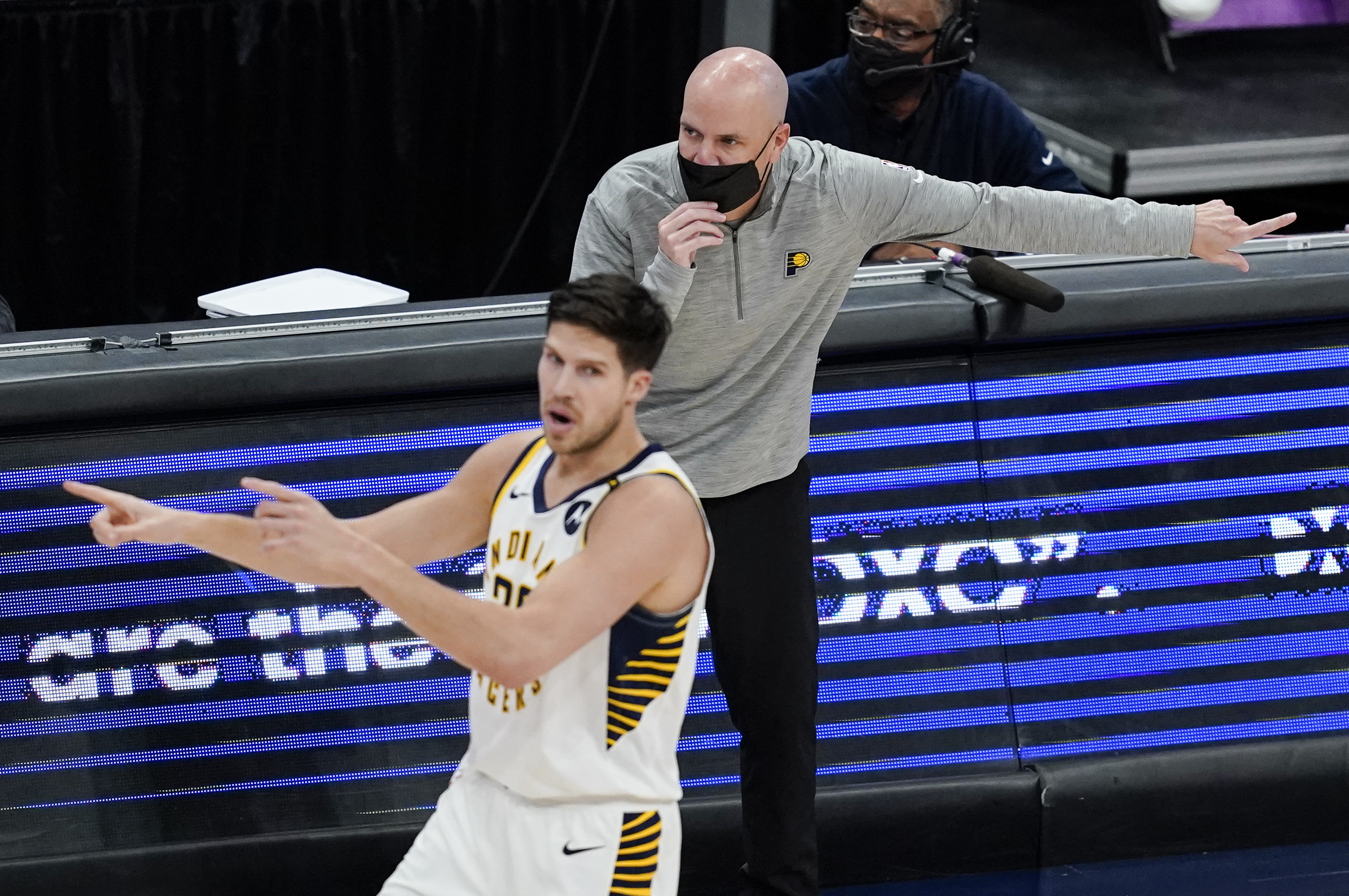 Indiana Pacers head coach Nate Bjorkgren directs his team behind Indiana Pacers forward Doug McDermott (20) during the second half of a basketball game against the Washington Wizards, Monday, May 3, 2021, in Washington. (AP Photo/Alex Brandon)