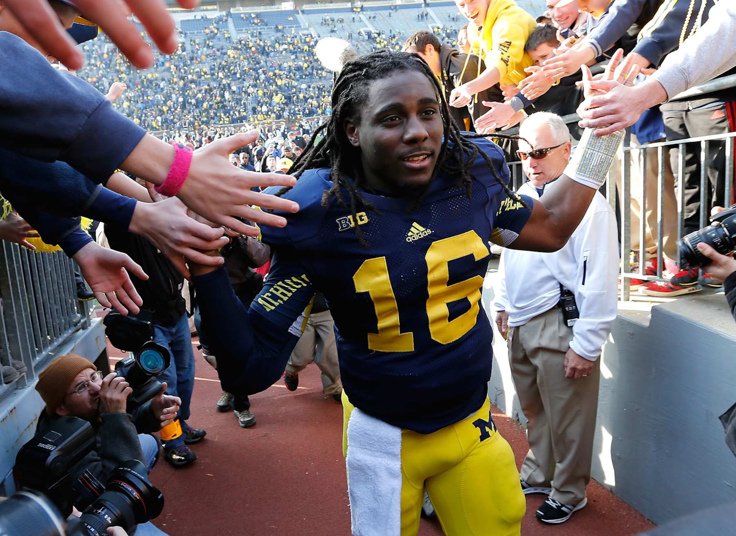ANN ARBOR, MI - NOVEMBER 17:  Denard Robinson #16 of the Michigan Wolverines leaves the field after a 42-17 win over the Iowa Hawkeyes at Michigan Stadium on November 17, 2012 in Ann Arbor, Michigan. (Photo by Gregory Shamus/Getty Images)