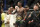 Israel Adesanya, center, reacts after winning a middleweight title bout against Jared Cannonier during the UFC 276 mixed martial arts event Saturday, July 2, 2022, in Las Vegas. (AP Photo/John Locher)