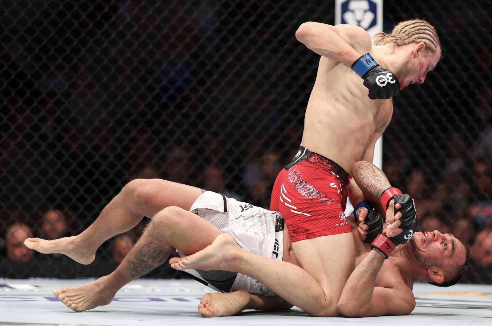 LAS VEGAS, NEVADA - DECEMBER 16: Paddy Pimblett of England (top) punches Tony Ferguson of the United States in a lightweight fight during the UFC 296: Edwards vs. Covington event at T-Mobile Arena on December 16, 2023 in Las Vegas, Nevada. (Photo by Sean M. Haffey/Getty Images)