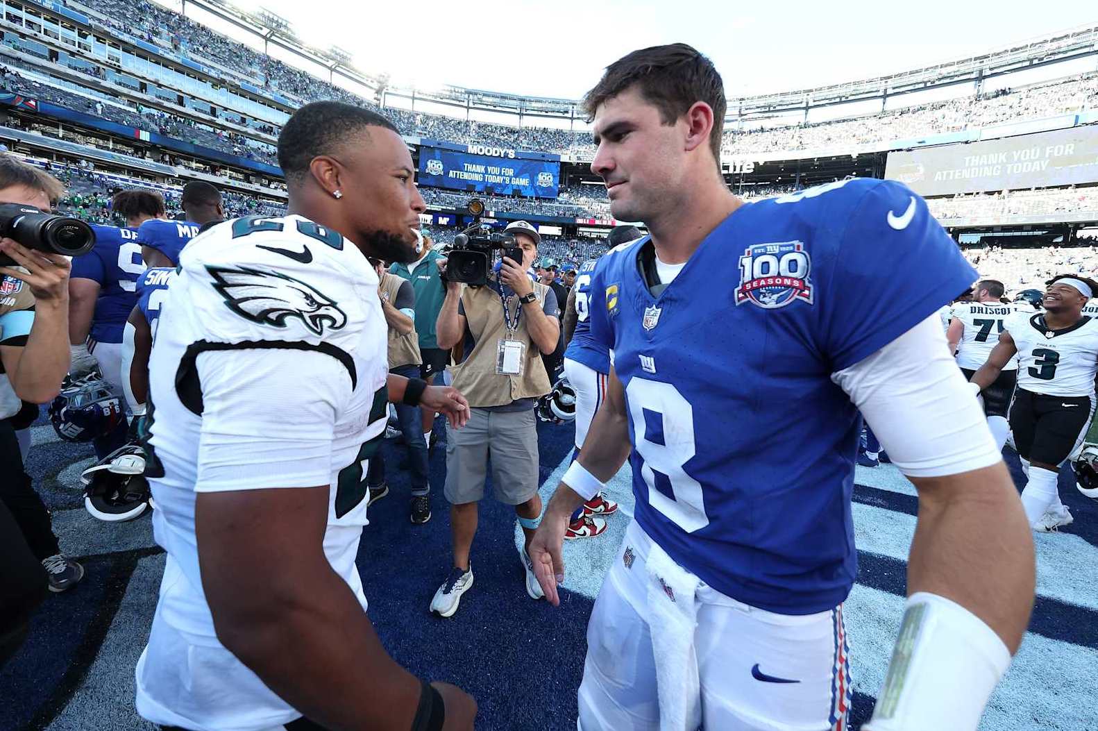 EAST RUTHERFORD, NEW JERSEY - OCTOBER 20: Saquon Barkley #26 of the Philadelphia Eagles shakes hands with Daniel Jones #8 of the New York Giants following the game at MetLife Stadium on October 20, 2024 in East Rutherford, New Jersey. Philadelphia defeated New York 28-3. (Photo by Al Bello/Getty Images)