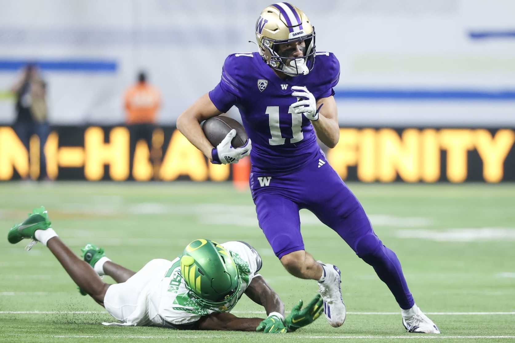 LAS VEGAS, NEVADA - DECEMBER 01: Jalen McMillan #11 of the Washington Huskies runs past Khyree Jackson #5 of the Oregon Ducks during the second quarter during the Pac-12 Championship at Allegiant Stadium on December 01, 2023 in Las Vegas, Nevada. (Photo by Ian Maule/Getty Images)
