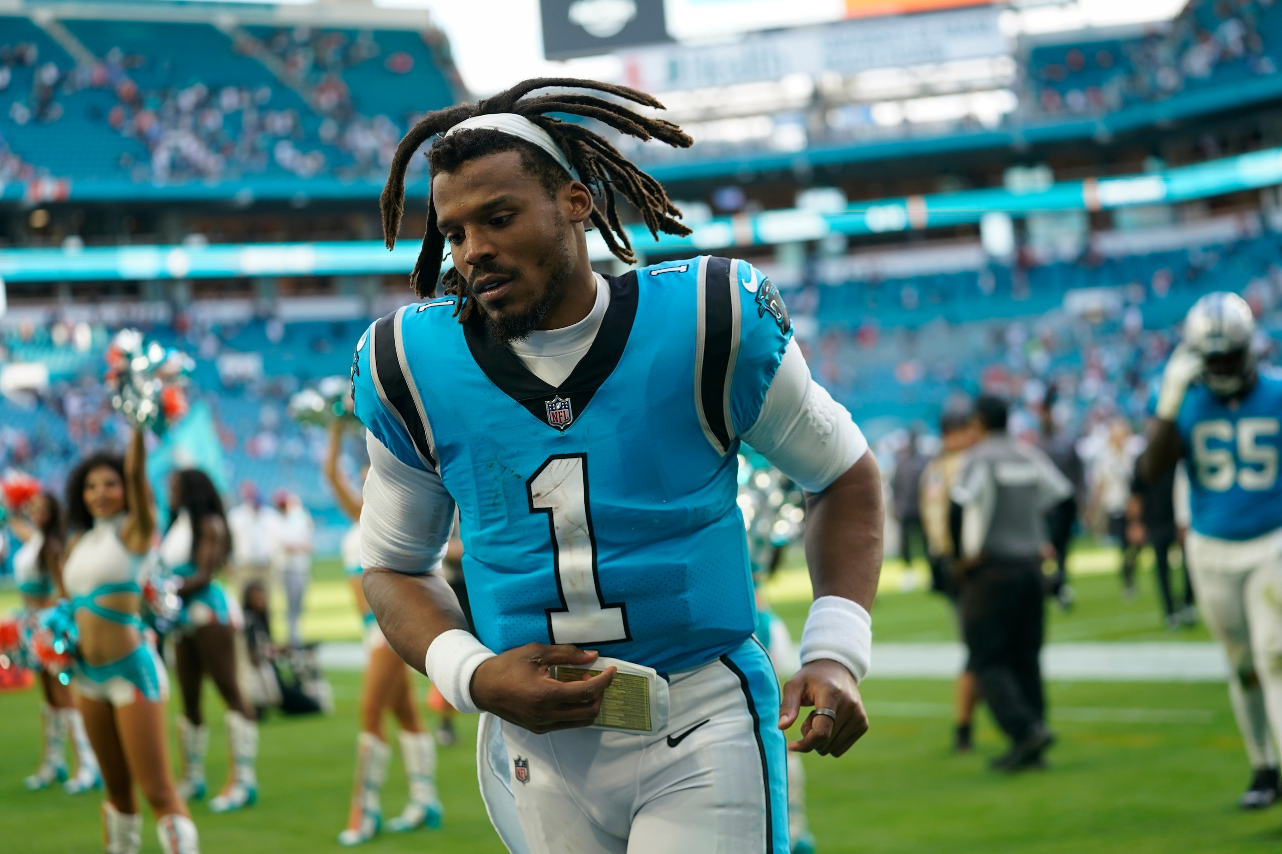 Carolina Panthers quarterback Cam Newton (1) jogs off the field at the end of an NFL football game against the Miami Dolphins, Sunday, Nov. 28, 2021, in Miami Gardens, Fla. (AP Photo/Lynne Sladky)