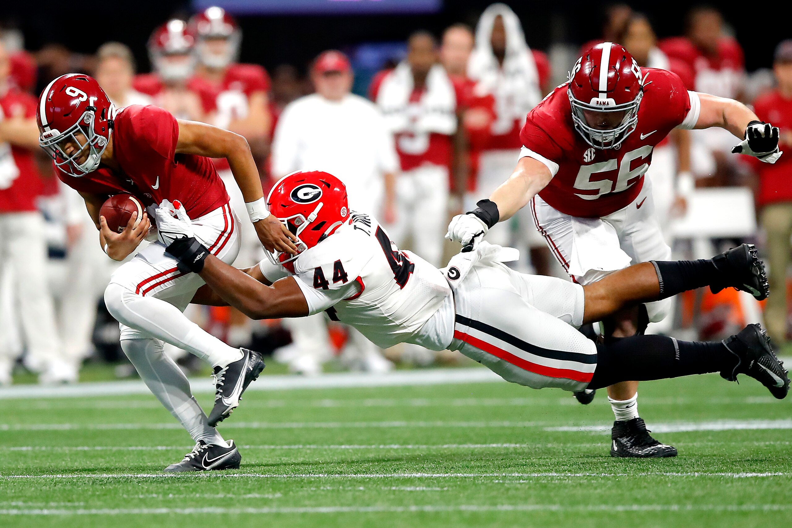 ATLANTA, GEORGIA - DECEMBER 04: Bryce Young #9 of the Alabama Crimson Tide runs with the ball as Travon Walker #44 of the Georgia Bulldogs defends in the second quarter of the SEC Championship game against the Georgia Bulldogs at Mercedes-Benz Stadium on December 04, 2021 in Atlanta, Georgia. (Photo by Todd Kirkland/Getty Images)