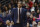 FILE - In this Feb. 25, 2018, file photo, then-Connecticut coach Kevin Ollie watches during the first half the team's NCAA college basketball game in Storrs, Conn. Former Connecticut head coach Kevin Ollie has been brought on board in a leadership role for a new basketball league designed to offer elite high school players another pathway to the pros. Ollie will serve as coach and director of player development for Overtime Elite, which markets itself to 16-to-18 year old players with guarantees of academic education and a six-figure salary. (AP Photo/Jessica Hill, File)
