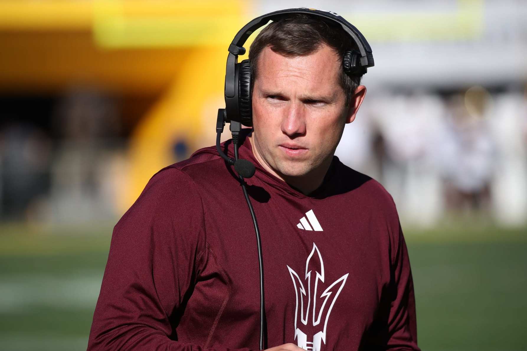 TEMPE, ARIZONA - NOVEMBER 25: Head Coach Kenny Dillingham of the Arizona State Sun Devils looks to the sidelines while talking on his headset during the University of Arizona Wildcats versus the Arizona State Sun Devils football game at Mountain America Stadium on November 25, 2023 in Tempe, Arizona. (Photo by Bruce Yeung/Getty Images)