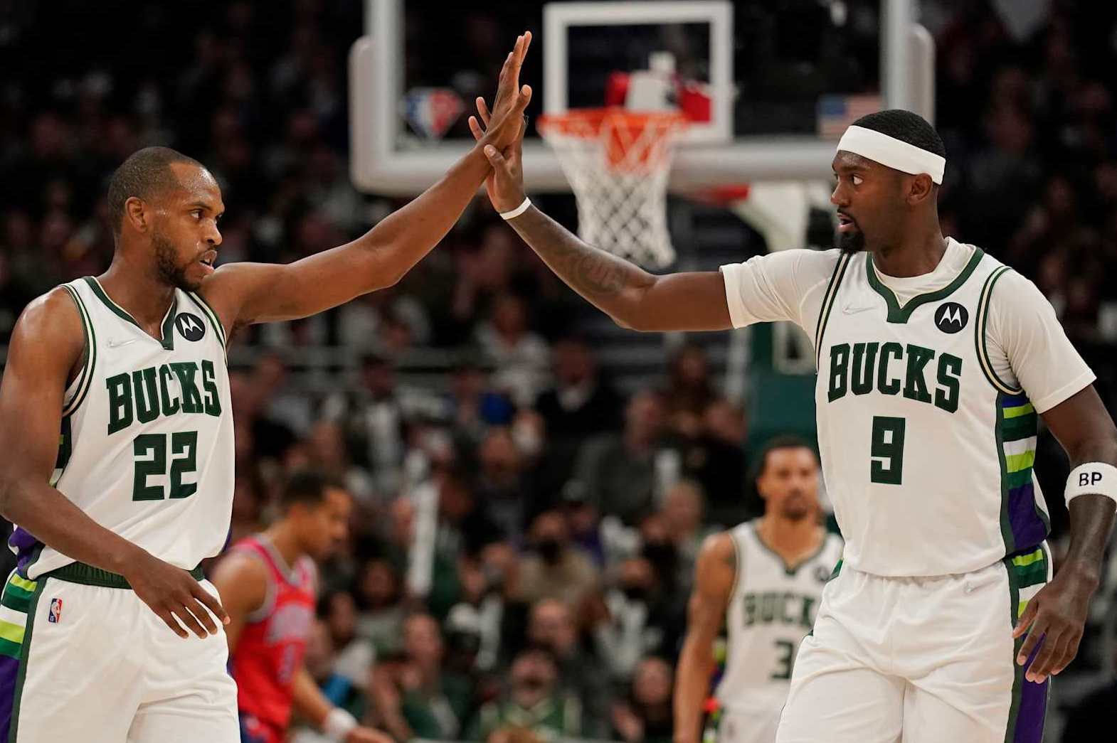 MILWAUKEE, WISCONSIN - NOVEMBER 24: Khris Middleton #22 and Bobby Portis #9 of the Milwaukee Bucks celebrate in the second half against the Detroit Pistons at Fiserv Forum on November 24, 2021 in Milwaukee, Wisconsin. NOTE TO USER: User expressly acknowledges and agrees that, by downloading and or using this photograph, user is consenting to the terms and conditions of the Getty Images License Agreement. (Photo by Patrick McDermott/Getty Images)