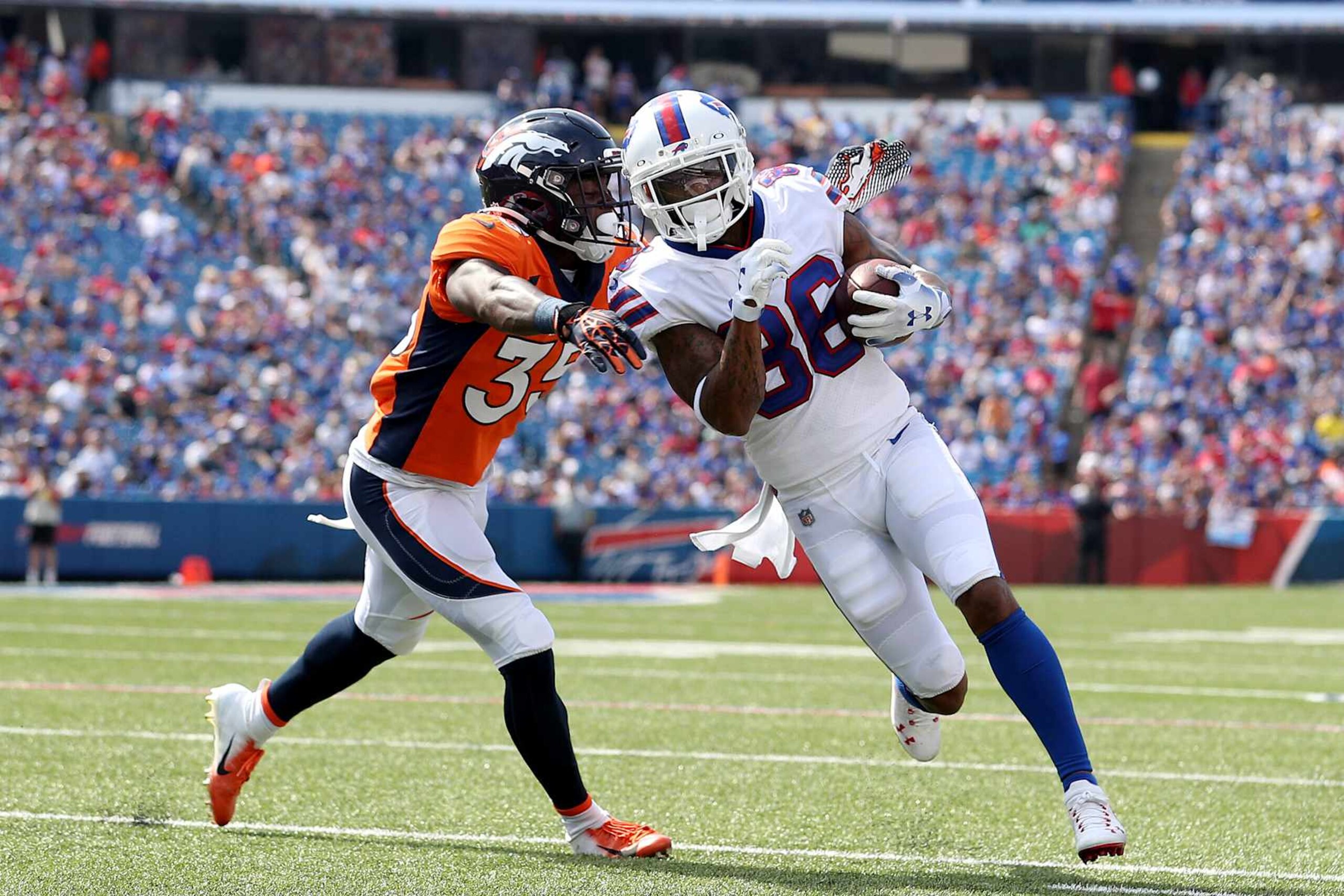 ORCHARD PARK, NEW YORK - AUGUST 20: Ja'Quan McMillian #35 of the Denver Broncos tackles Tavon Austin #86 of the Buffalo Bills during the third quarter of a preseason game at Highmark Stadium on August 20, 2022 in Orchard Park, New York. (Photo by Bryan M. Bennett/Getty Images)