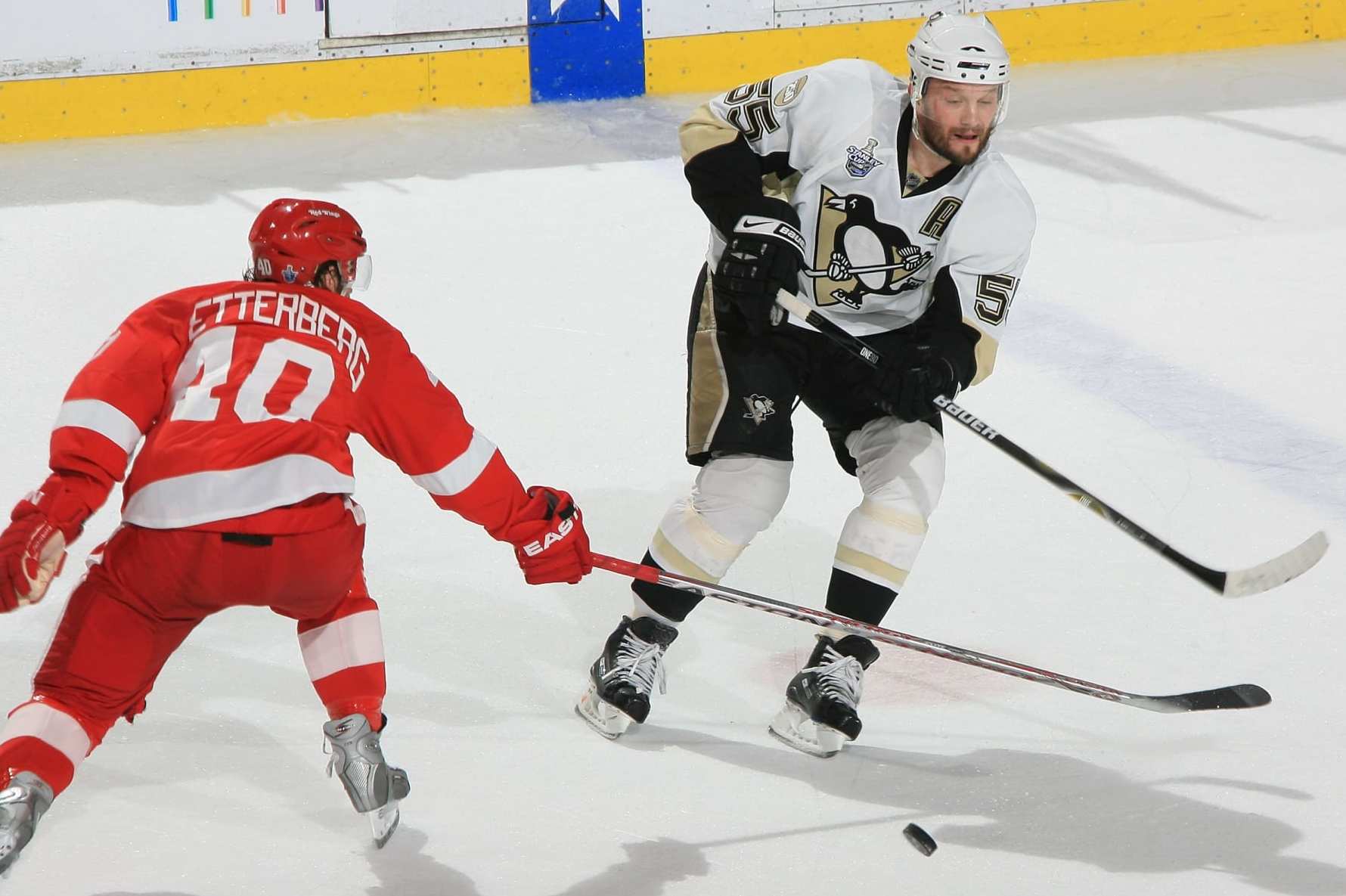 DETROIT - MAY 26: Sergei Gonchar #55 of the Pittsburgh Penguins passes the puck under the stick of Henrik Zetterberg #40 of the Detroit Red Wings chases during game two of the 2008 NHL Stanley Cup Finals at Joe Louis Arena on May 26, 2008 in Detroit, Michigan. The Wings won 3-0 (Photo by Dave Reginek/NHLI via Getty Images)
