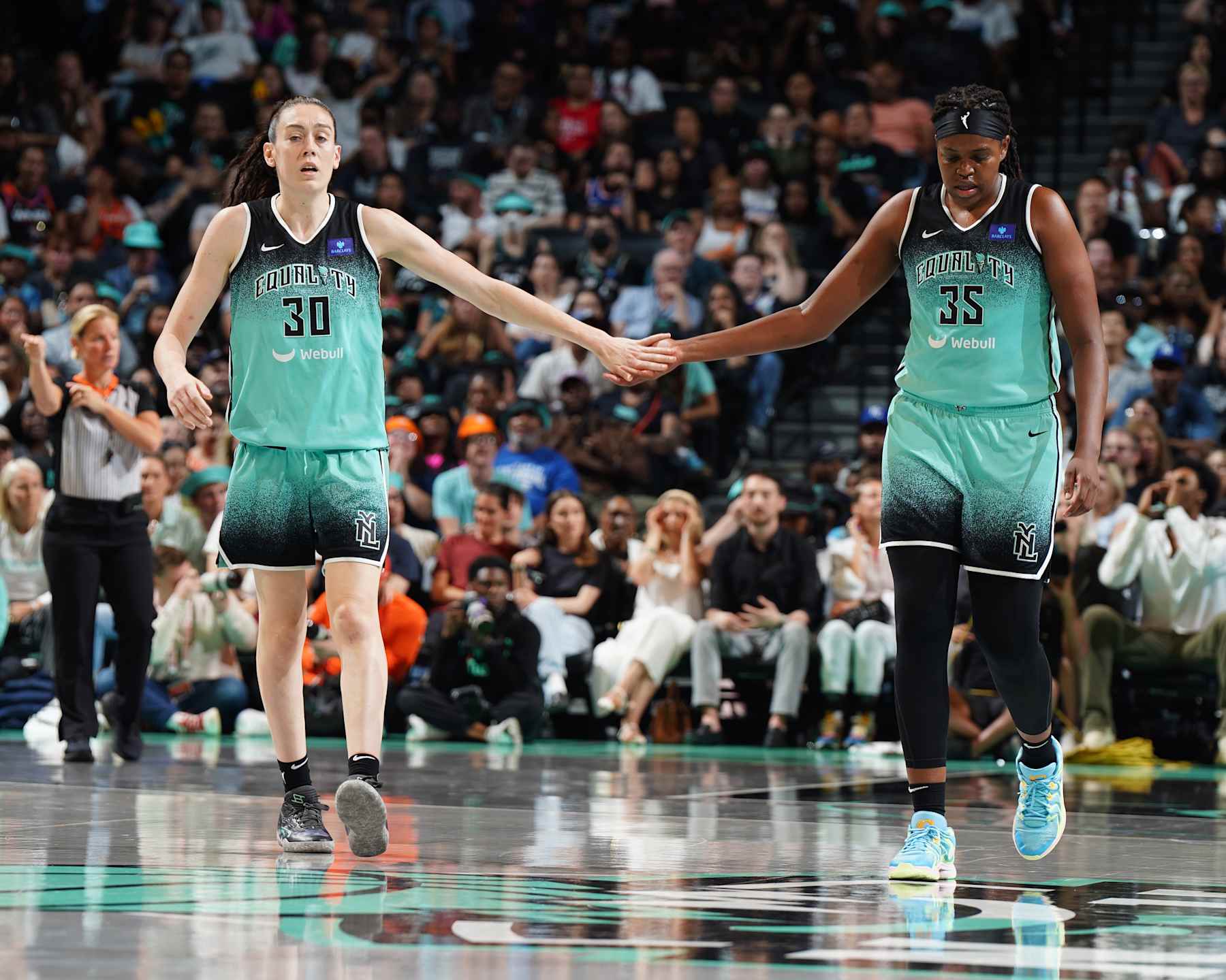 BROOKLYN, NY - AUGUST 24: Breanna Stewart #30 and Jonquel Jones #35 of the New York Liberty high fives  during the game on August 24, 2024 at the Barclays Center in Brooklyn, New York. NOTE TO USER: User expressly acknowledges and agrees that, by downloading and or using this photograph, user is consenting to the terms and conditions of the Getty Images License Agreement. Mandatory Copyright Notice: Copyright 2023 NBAE (Photo by Catalina Fragoso/NBAE via Getty Images)